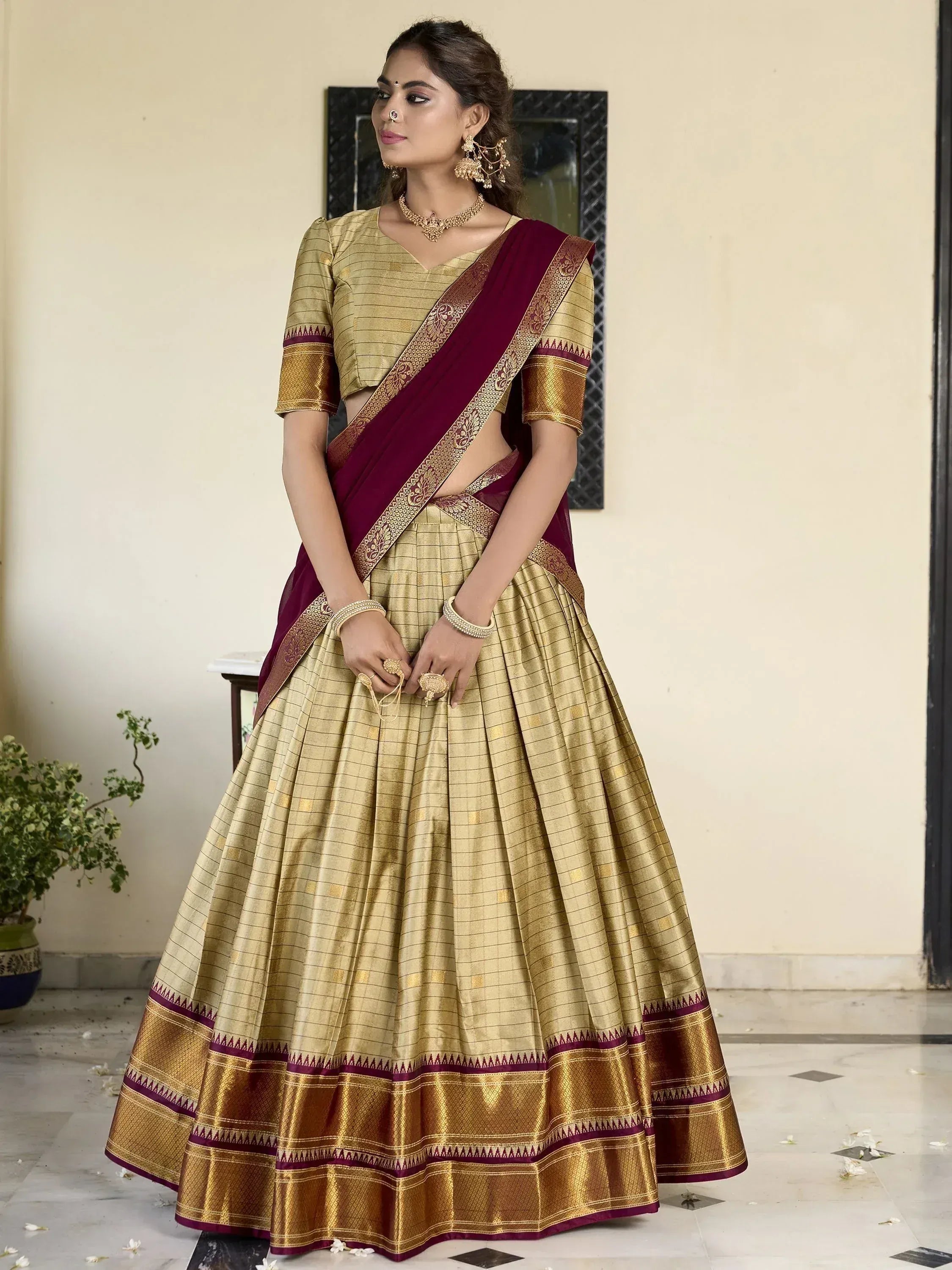 Gold and maroon designer lehenga choli with woven border, perfect for Indian ethnic occasions