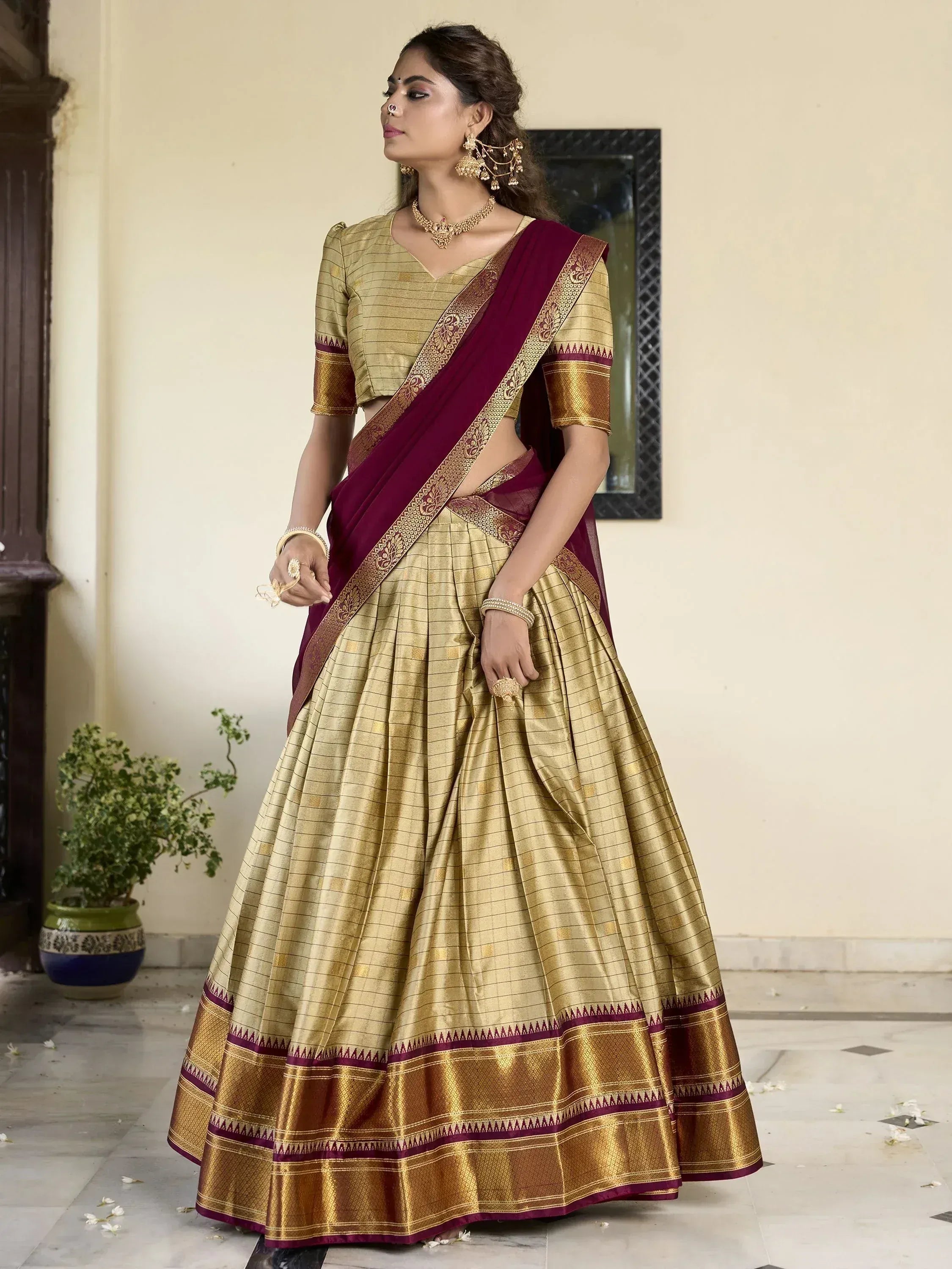 Gold and maroon designer lehenga choli with woven border, perfect for Indian ethnic wear occasions