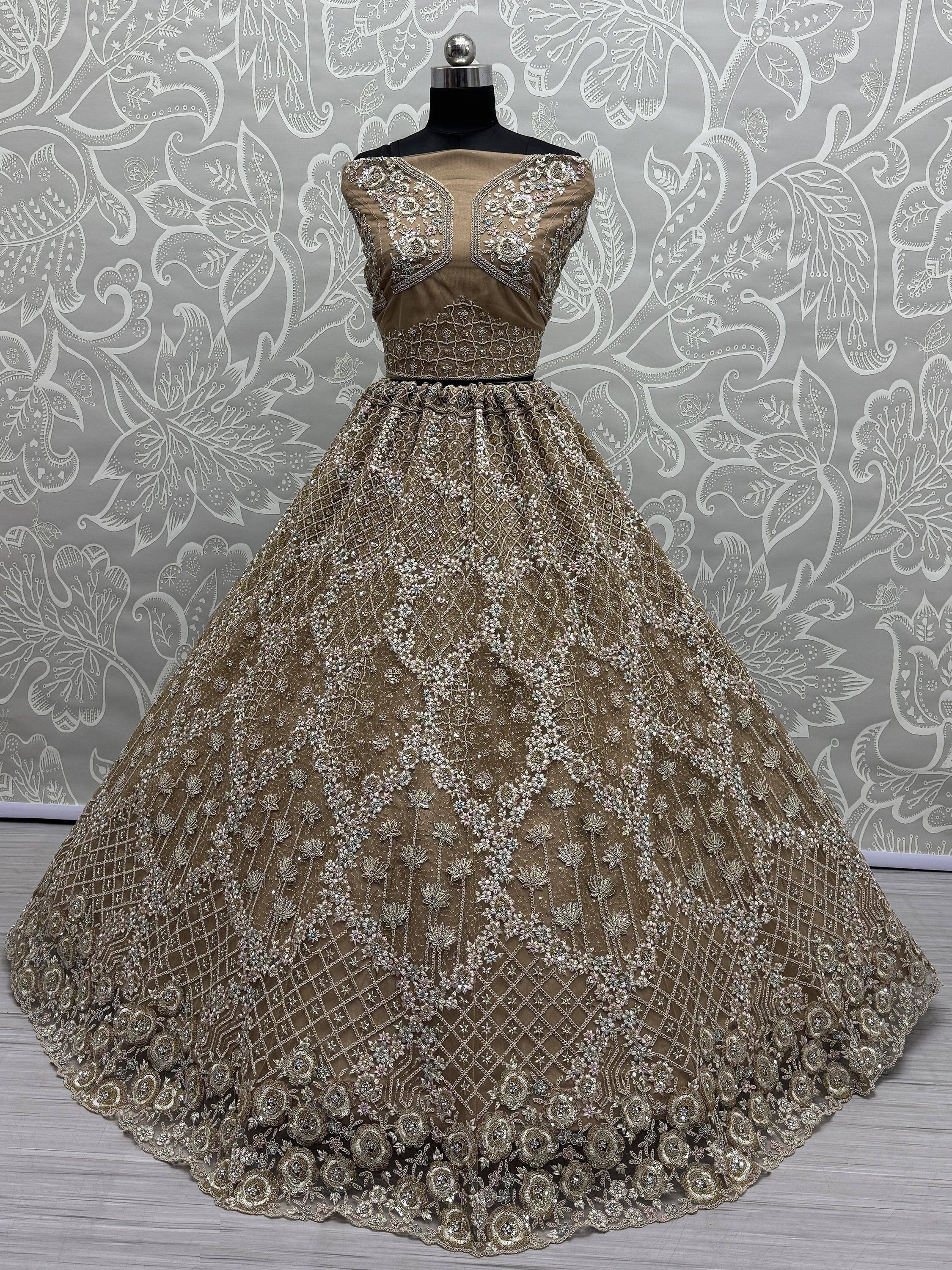 Gold embroidered ethnic gown with floral zari work, perfect for weddings and parties