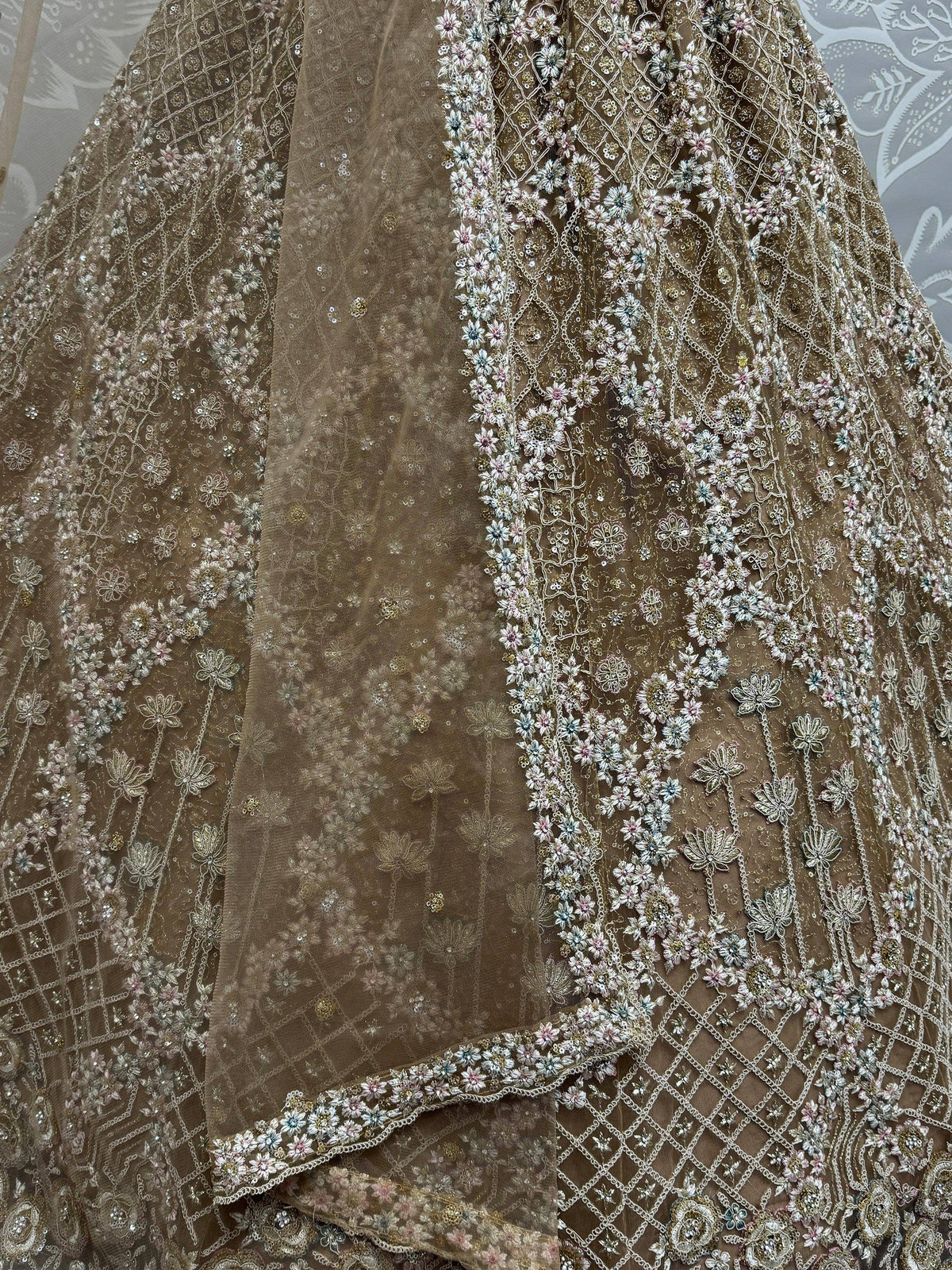 Elegant beige lehenga with intricate floral embroidery and sequin detailing, perfect for Indian ethnic wear.