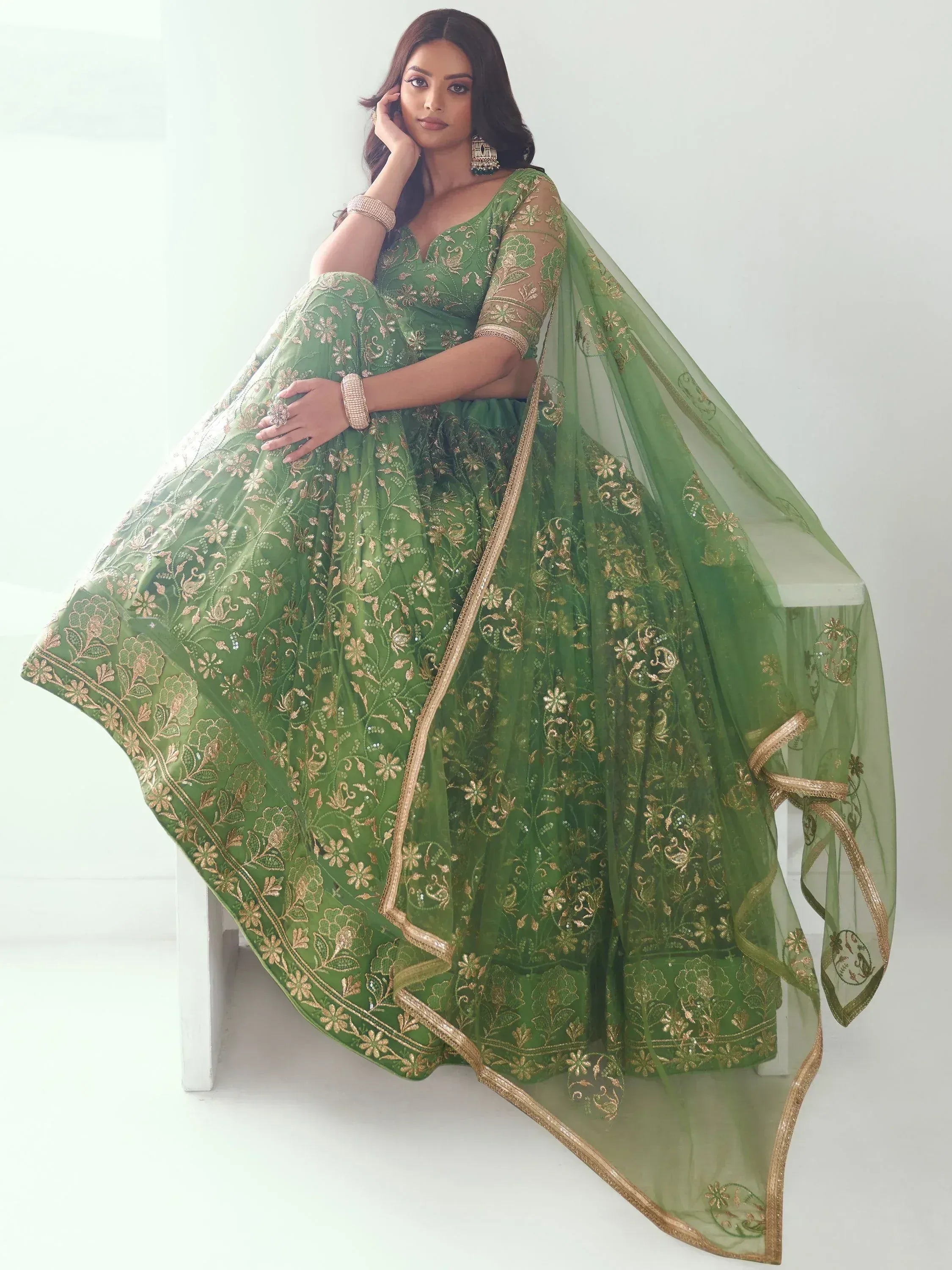 Green embroidered lehenga choli with gold floral work, perfect for Indian ethnic wear and festive occasions