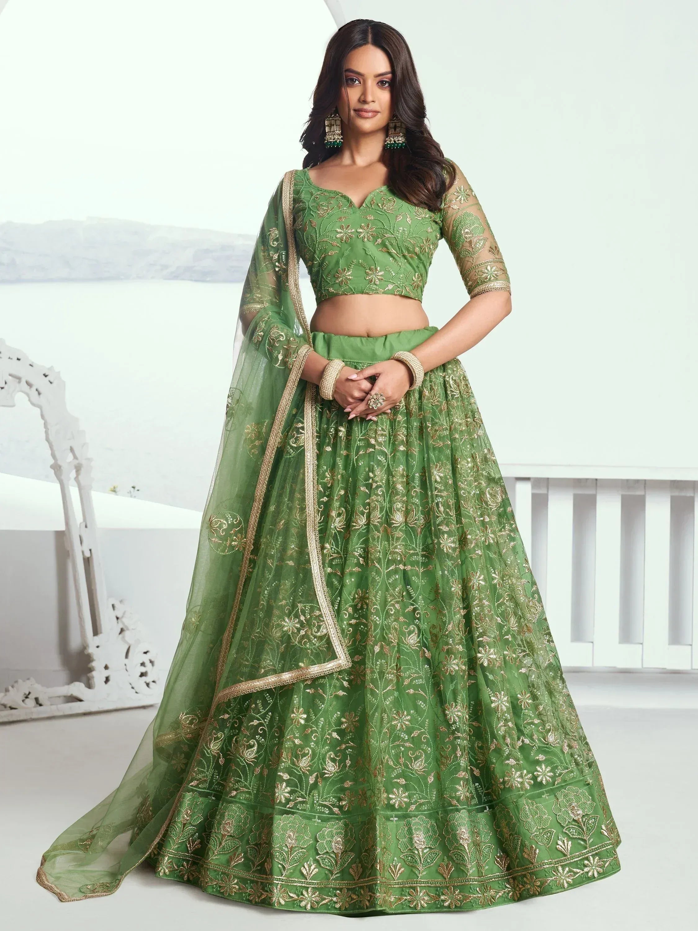 Green embroidered lehenga choli with gold detailing, perfect for ethnic occasions.