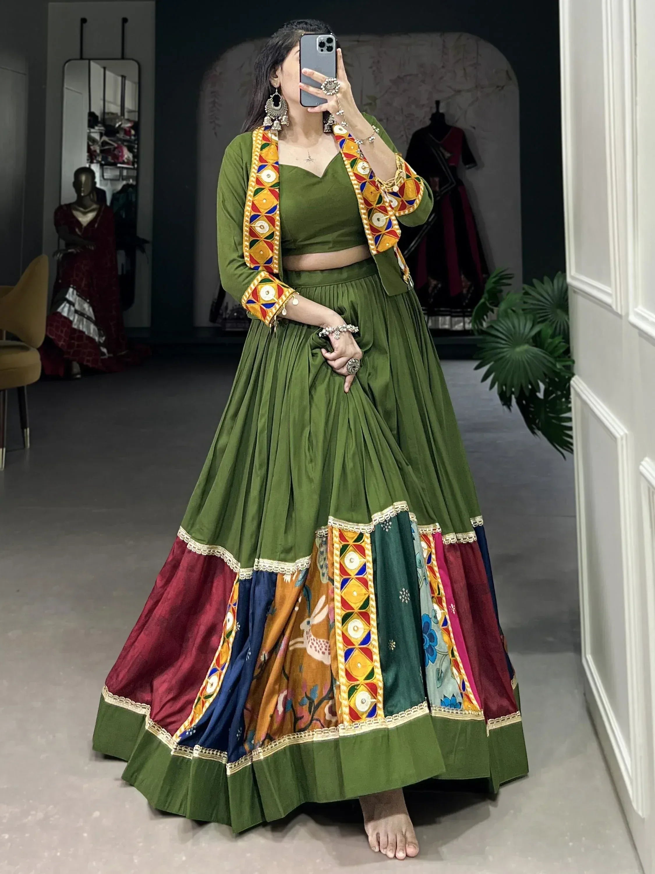 Olive green designer lehenga choli with colorful mirror work and patchwork skirt, perfect for Indian ethnic wear.