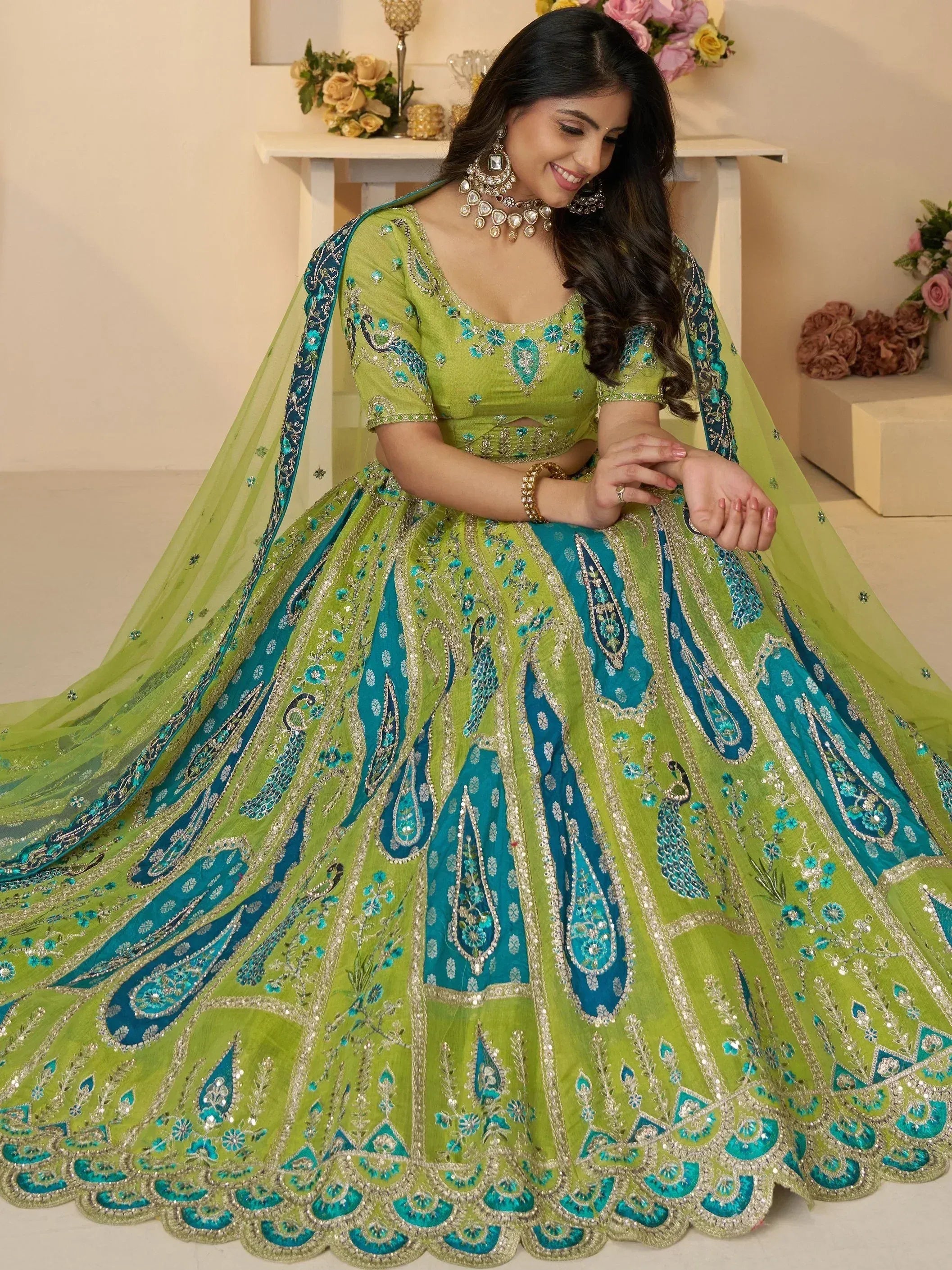 Green and teal designer lehenga choli with peacock embroidery and sequin work for Indian weddings