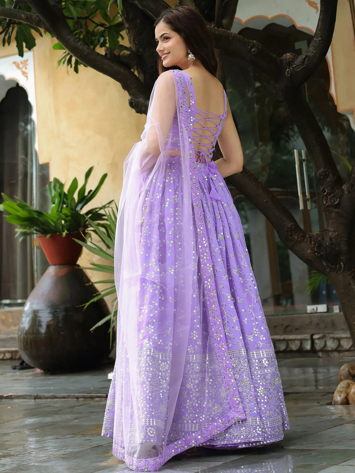 Lavender designer lehenga choli with silver embroidery, back lace-up detail, and sheer dupatta for Indian ethnic wear