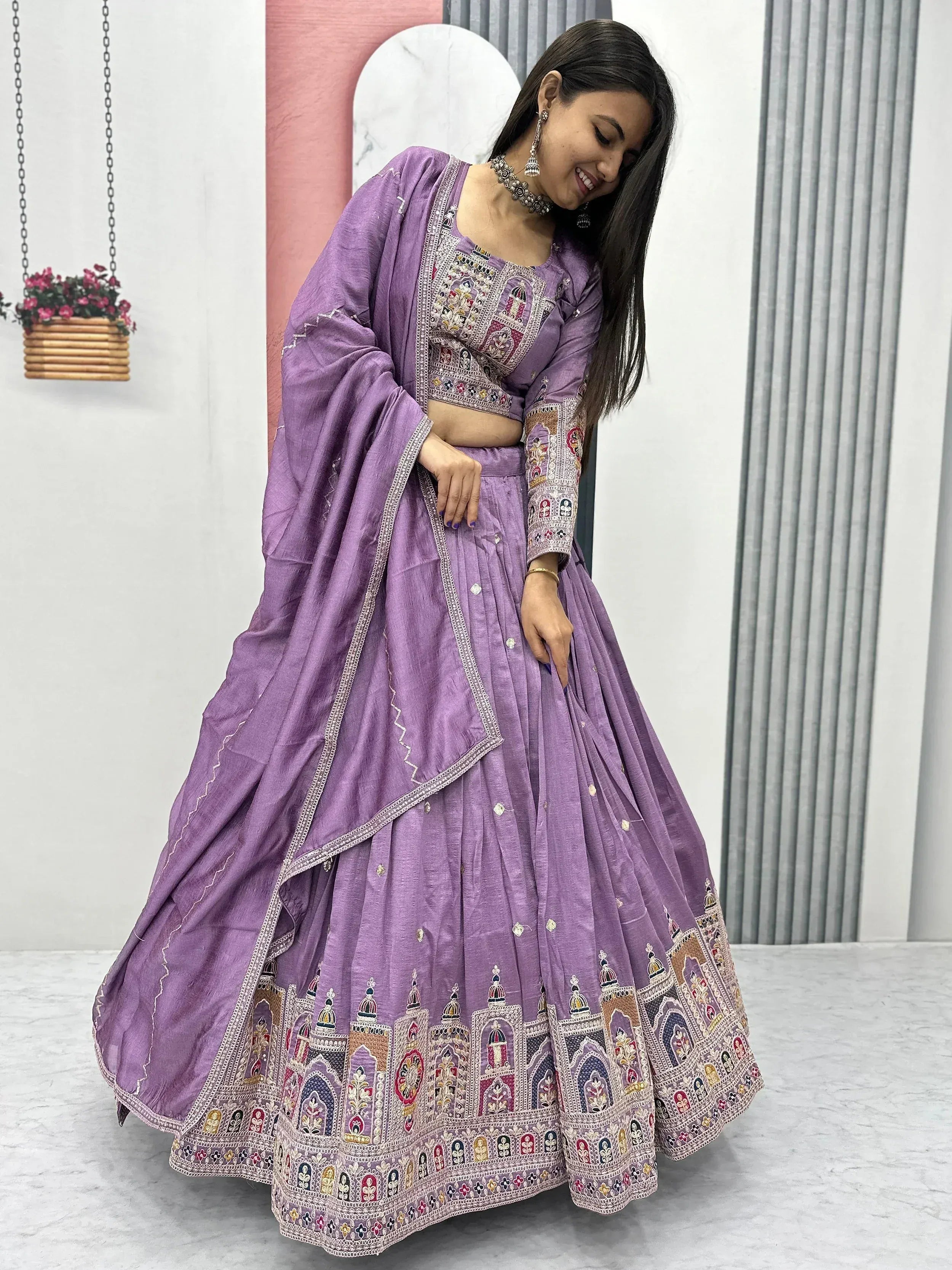 Purple embroidered lehenga choli with intricate mirror work, perfect for Indian ethnic wear occasions.