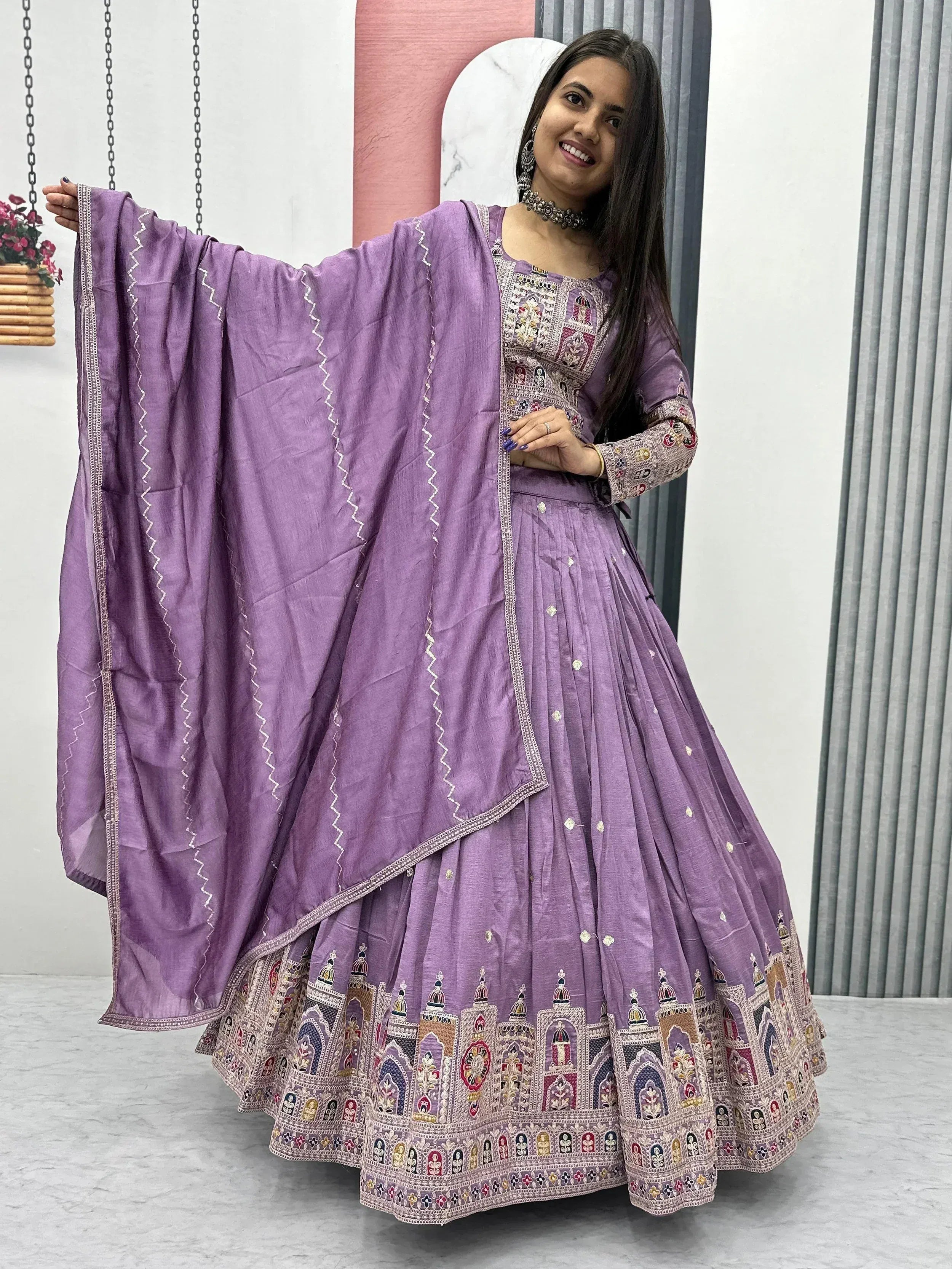 Purple embroidered lehenga choli with detailed temple motifs and matching dupatta, ideal for Indian ethnic occasions.
