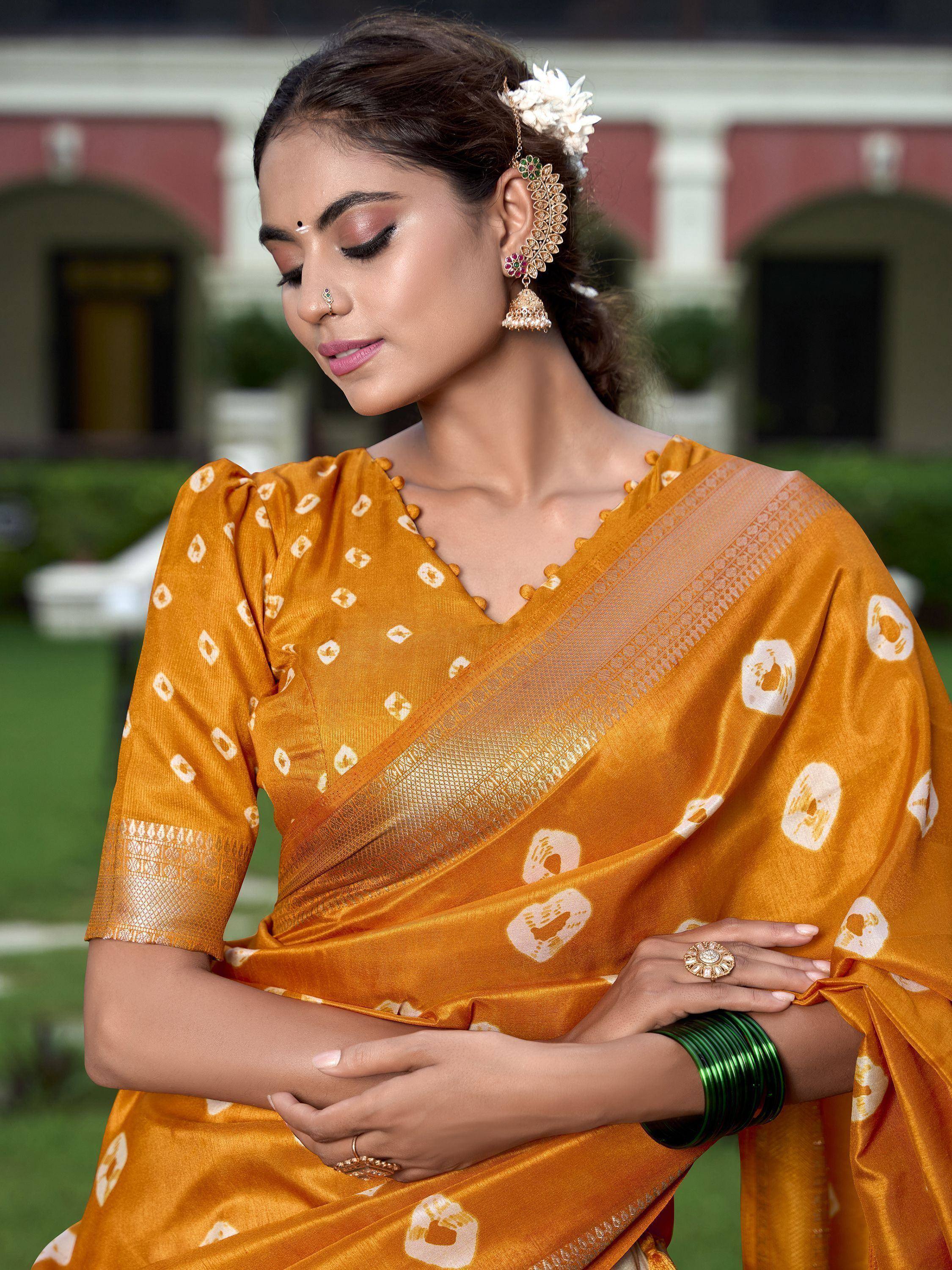 Woman in mustard yellow printed saree with gold border, traditional Indian ethnic wear