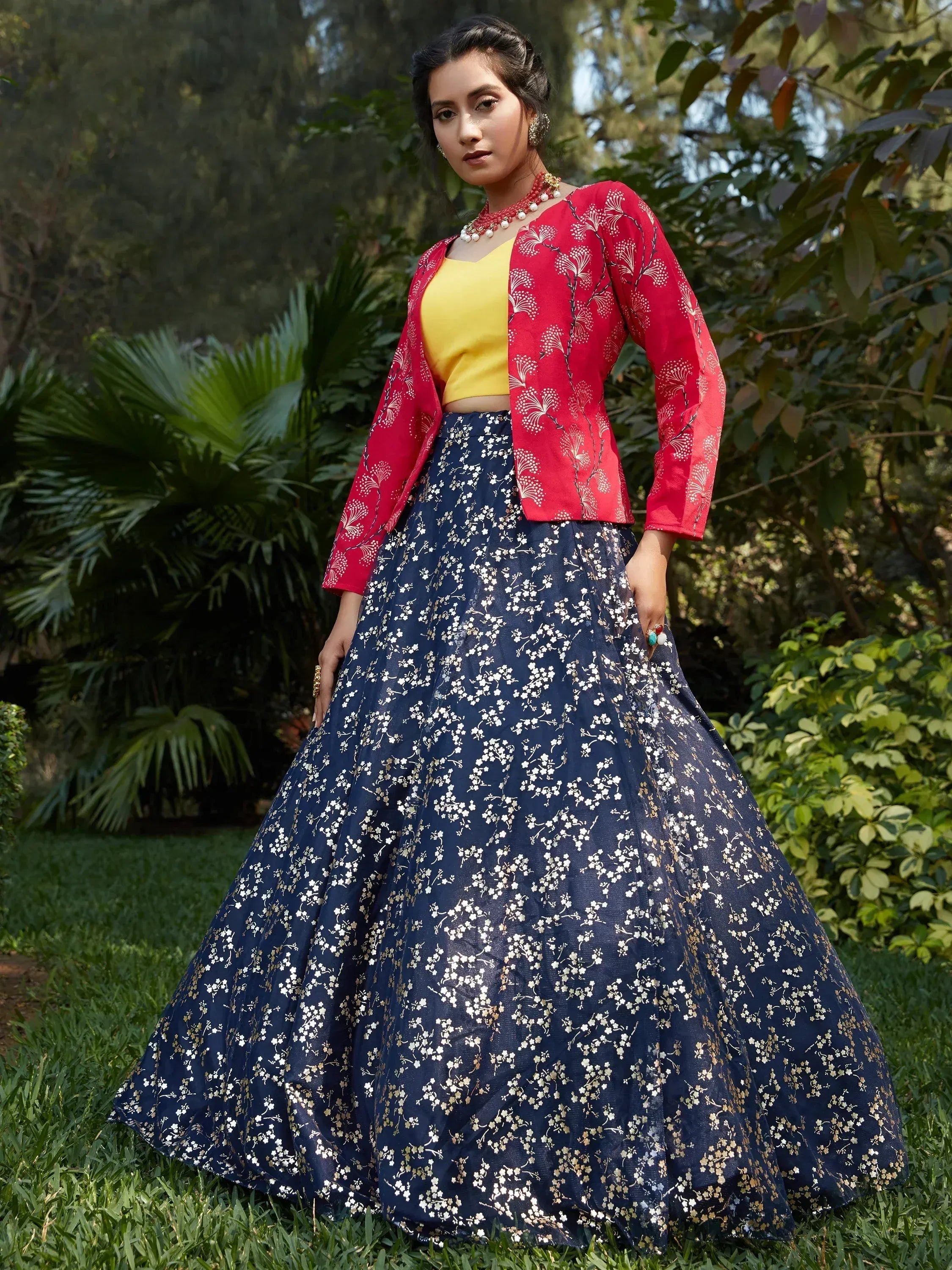 Woman in navy floral lehenga with red jacket and yellow blouse, Indian ethnic wear