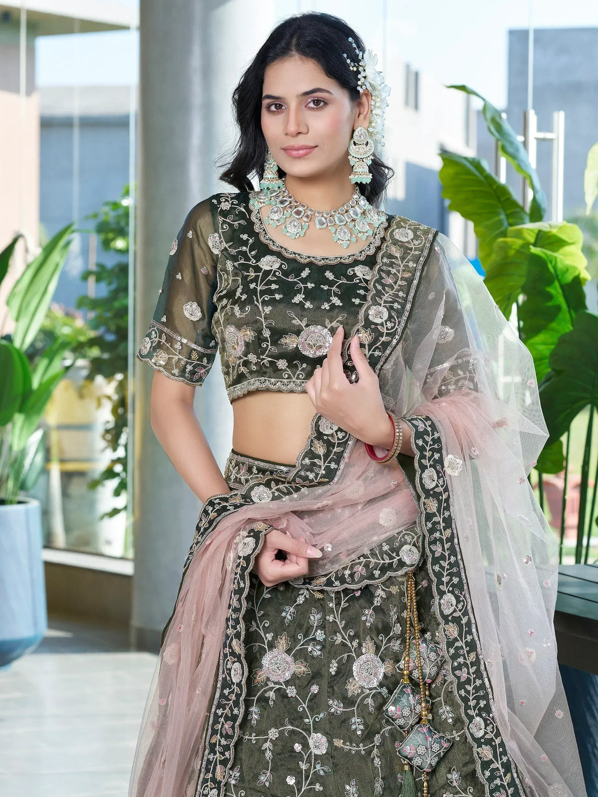 Elegant green embroidered lehenga choli with floral designs and sheer dupatta, perfect for Indian ethnic wear.
