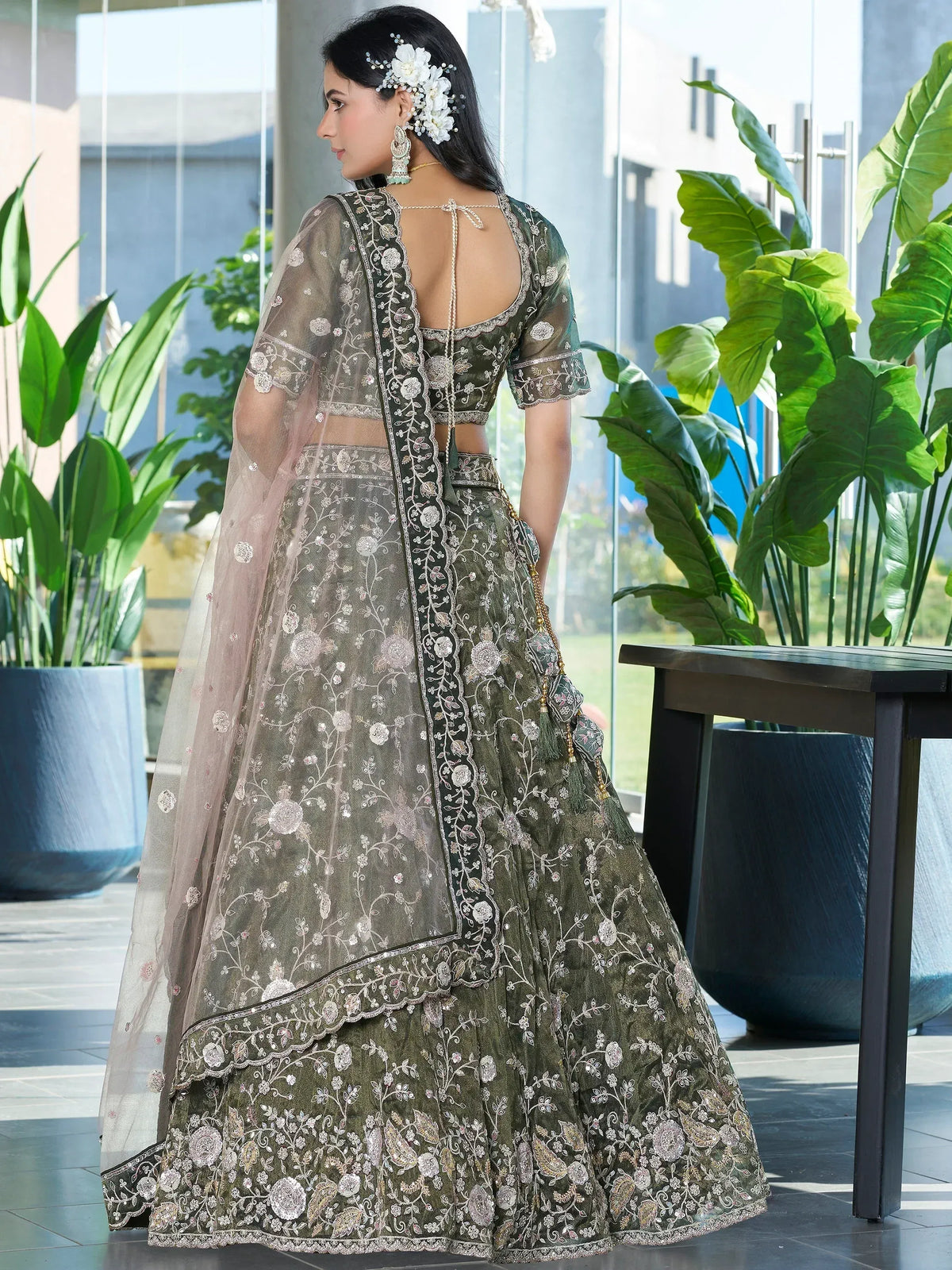 Elegant olive green lehenga choli with floral embroidery and sheer dupatta, perfect for Indian ethnic wear.