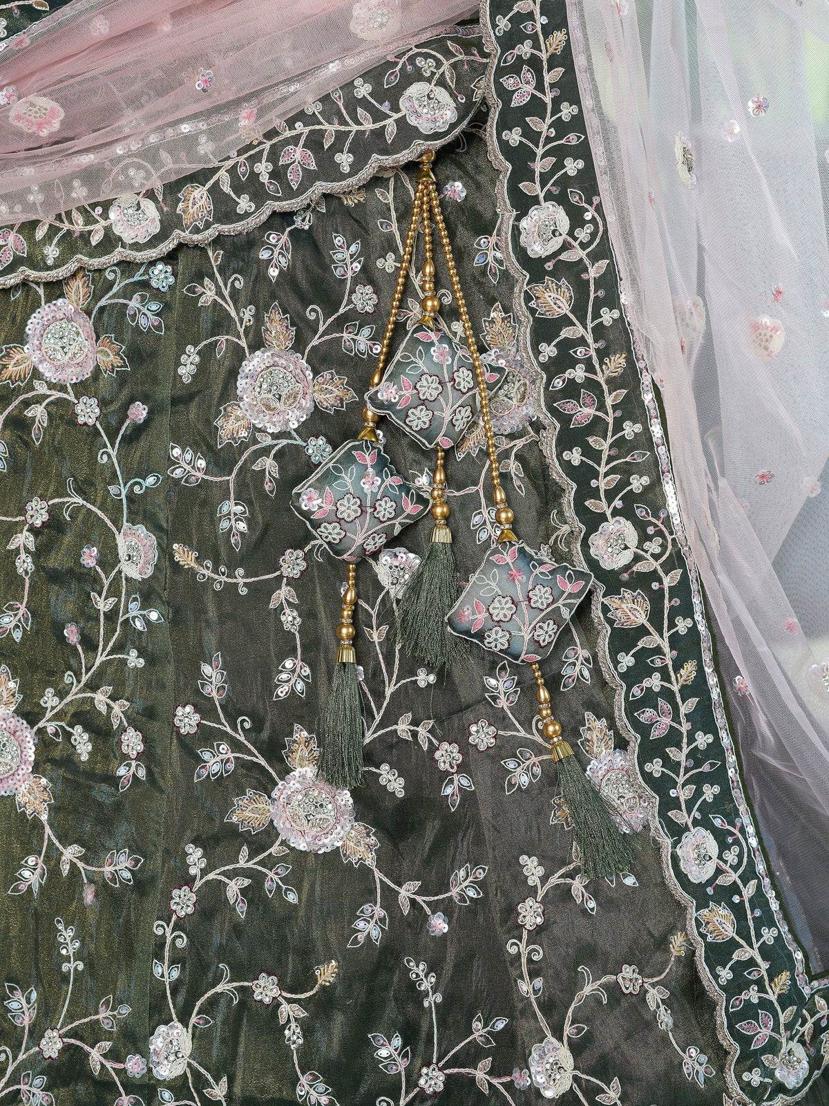 Elegant dark green lehenga with floral embroidery, tassels, and sheer dupatta for Indian ethnic wear