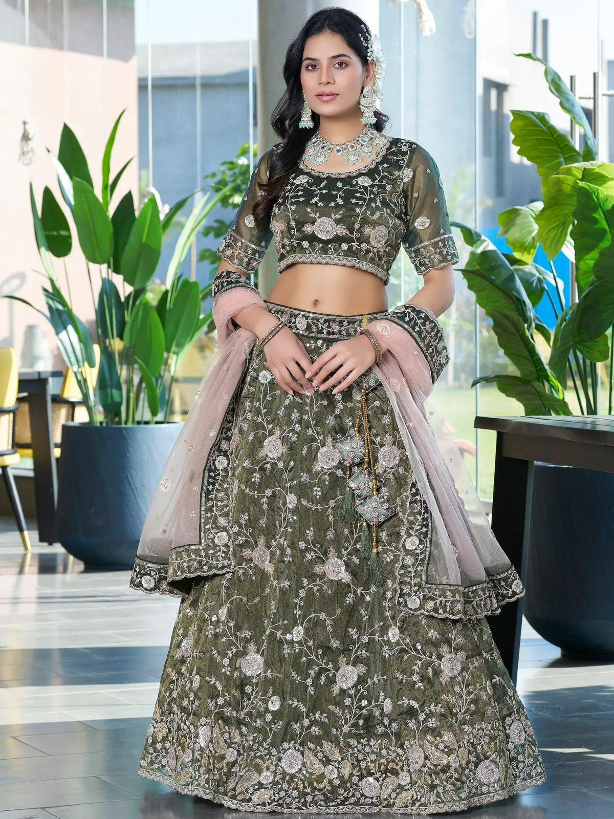 Olive green embroidered lehenga choli with floral motifs, sheer sleeves, and pink dupatta for Indian ethnic wear