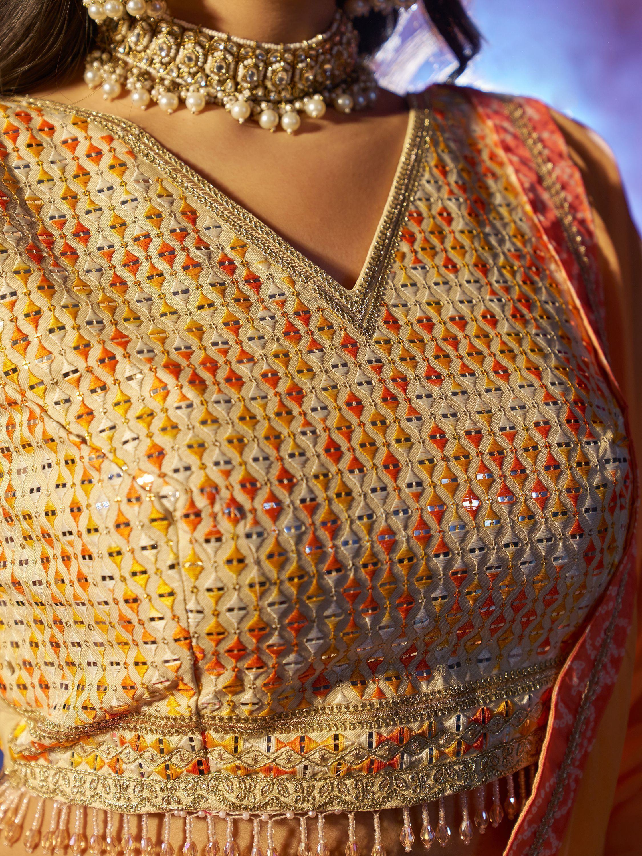 Designer ethnic blouse with intricate geometric embroidery and pearl choker necklace