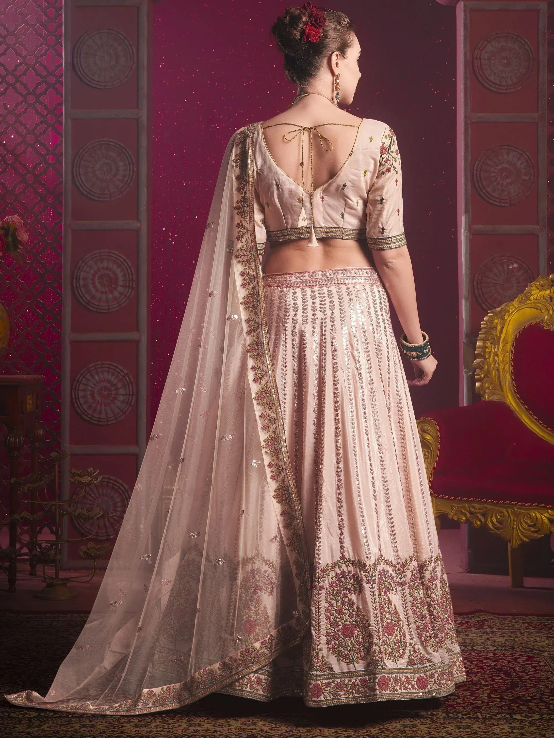 Elegant beige lehenga choli with floral embroidery and sheer dupatta, perfect for Indian weddings and festive occasions.