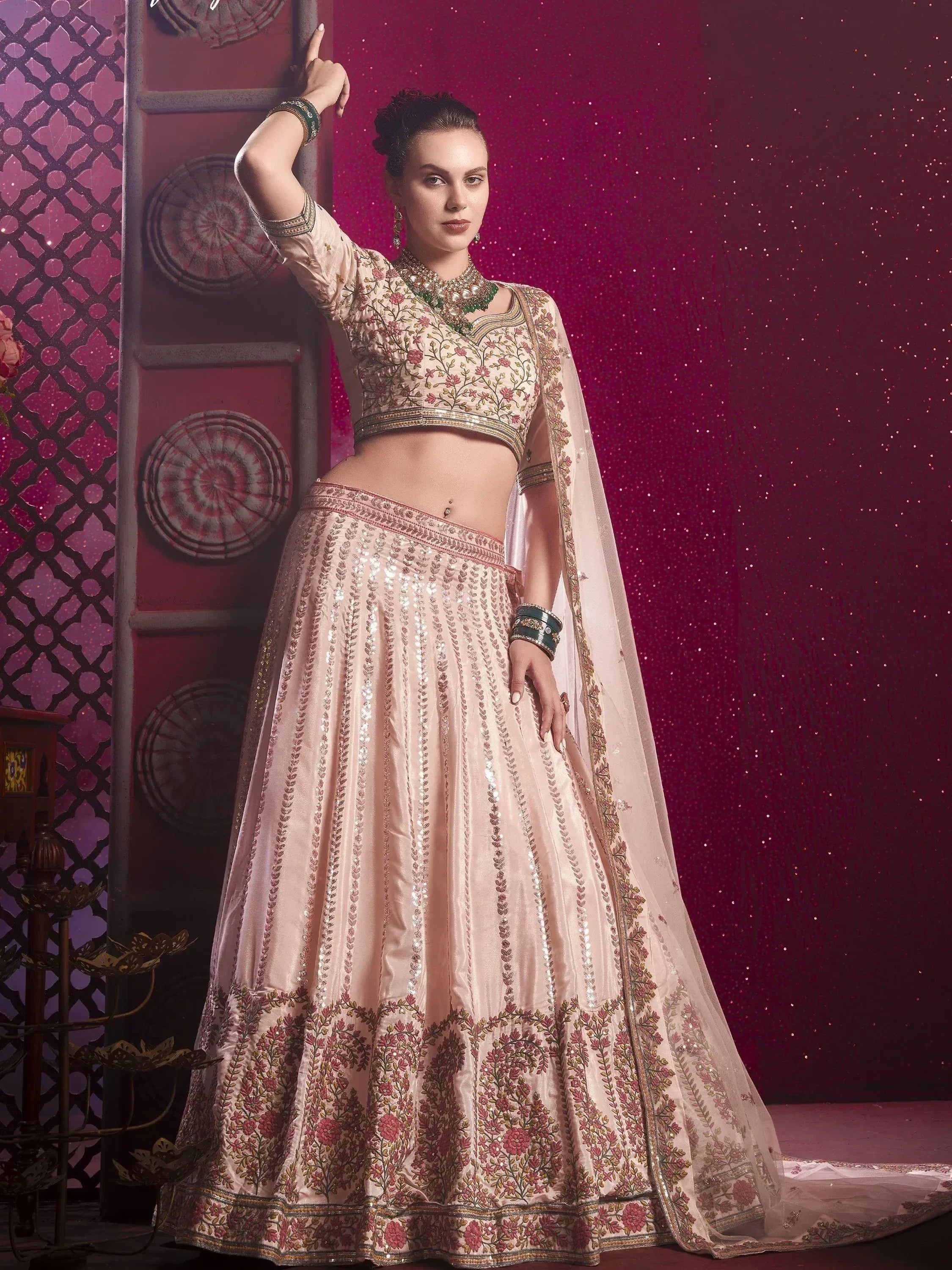 Elegant blush pink lehenga choli with floral embroidery and sequin detailing, perfect for Indian weddings and festive occasions.