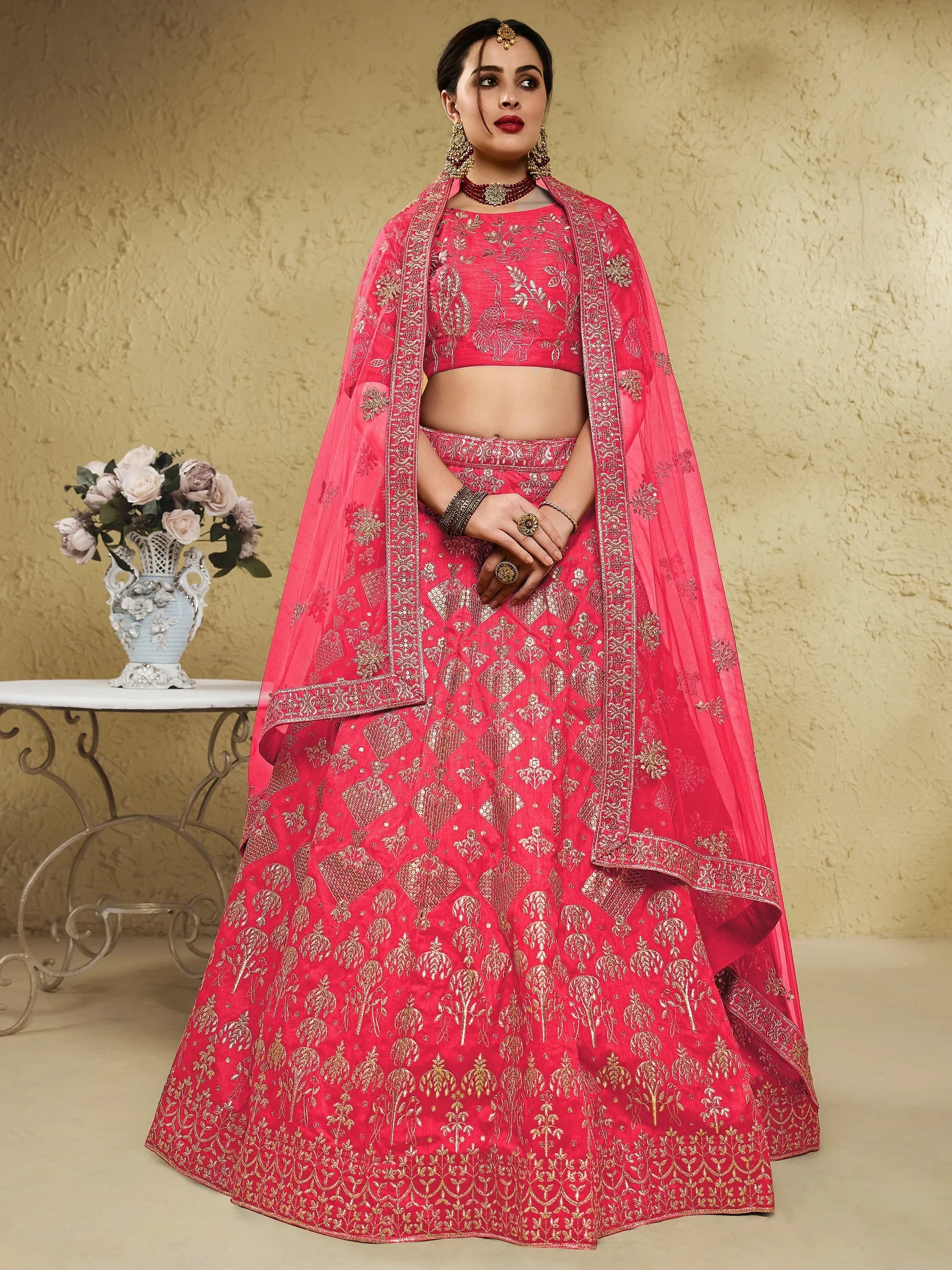 Pink embroidered lehenga choli with gold detailing, perfect for Indian weddings and festive occasions