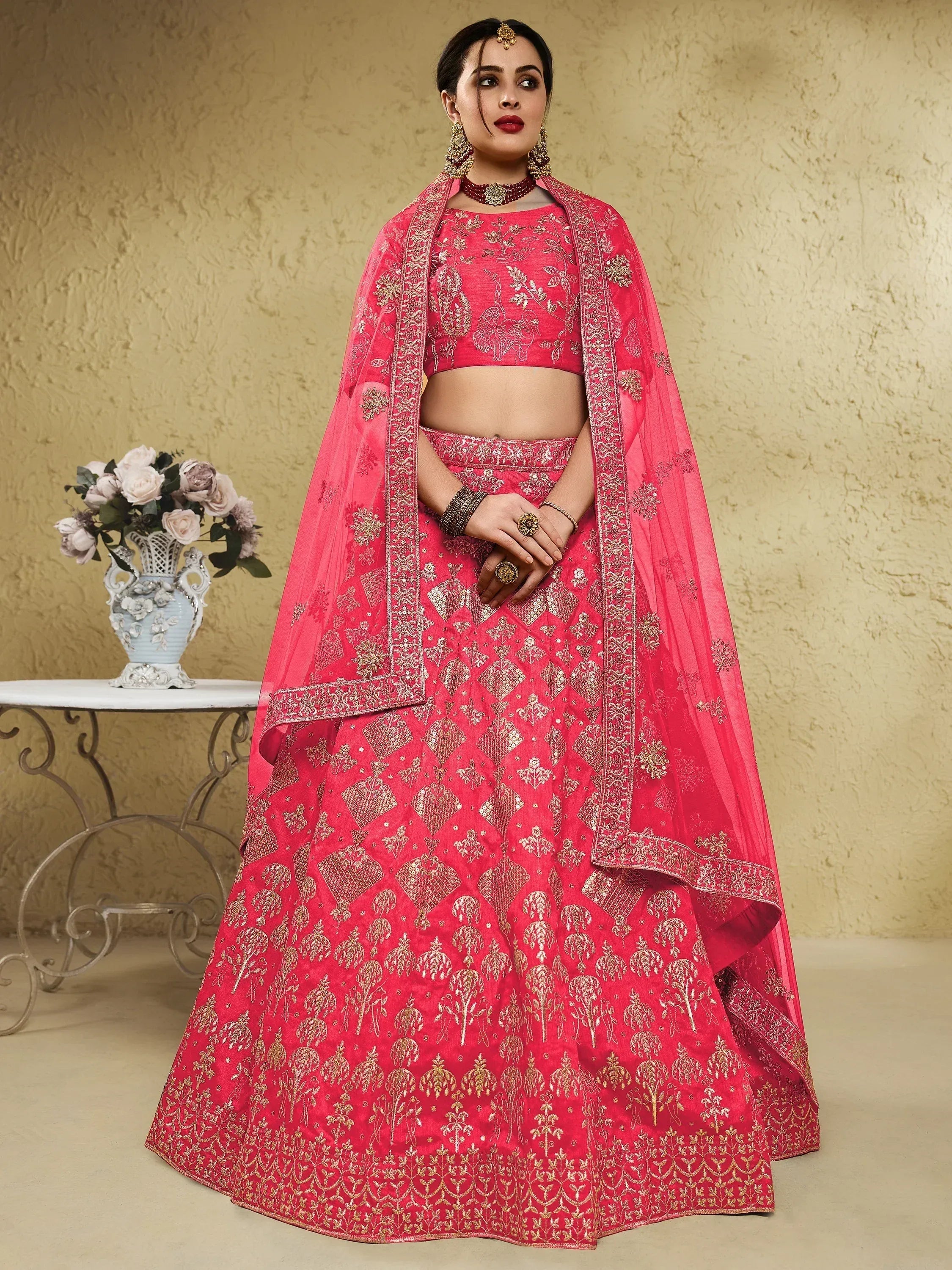 Pink embroidered lehenga choli with gold detailing, perfect for Indian weddings and festive occasions