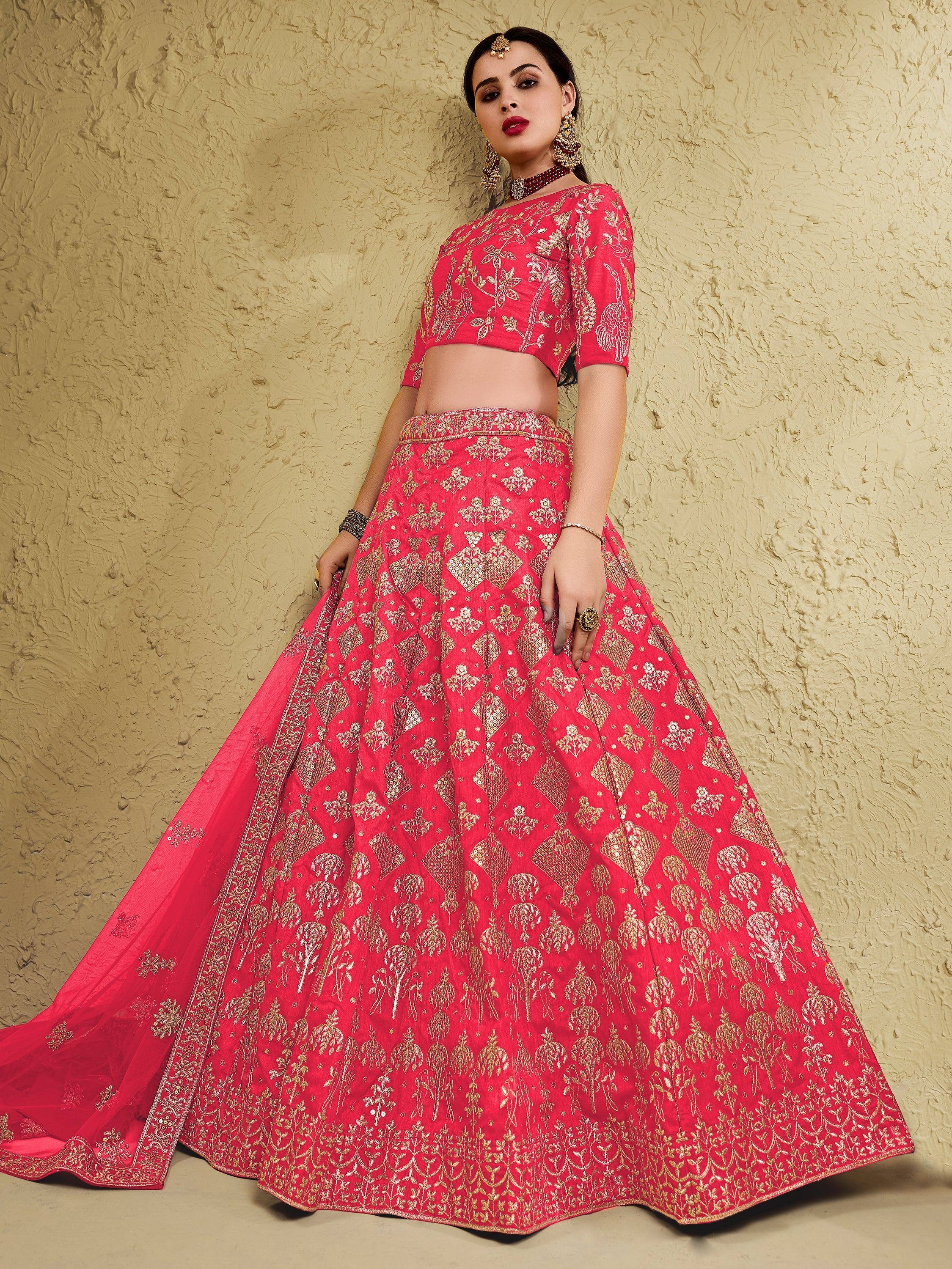 Red and gold embroidered lehenga choli with floral motifs, perfect for Indian weddings and festive occasions.