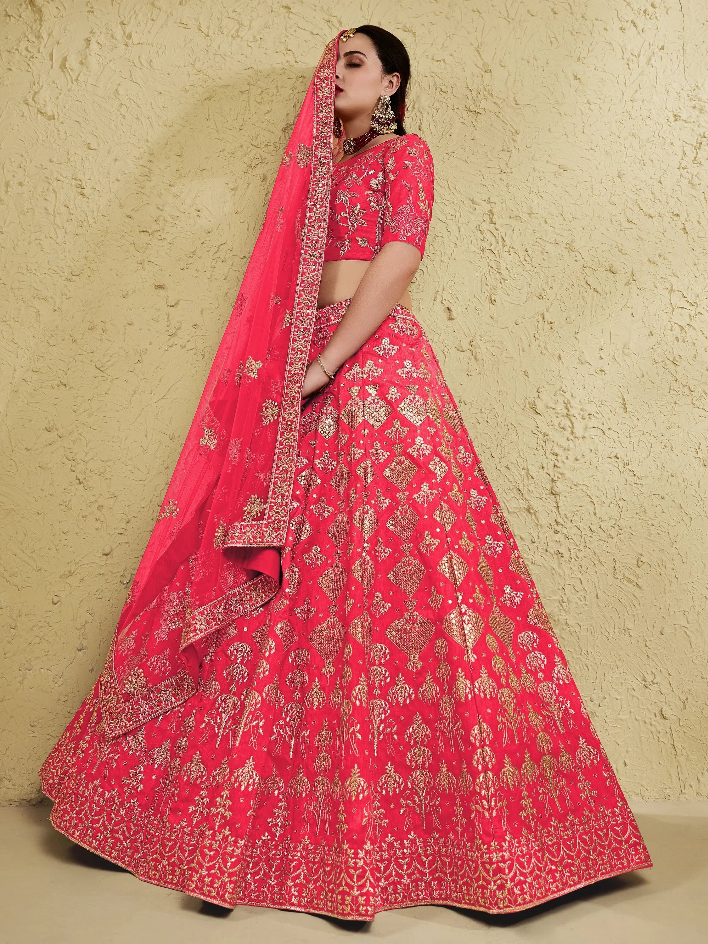 Pink designer lehenga choli with gold embroidery, perfect for Indian weddings and festive occasions