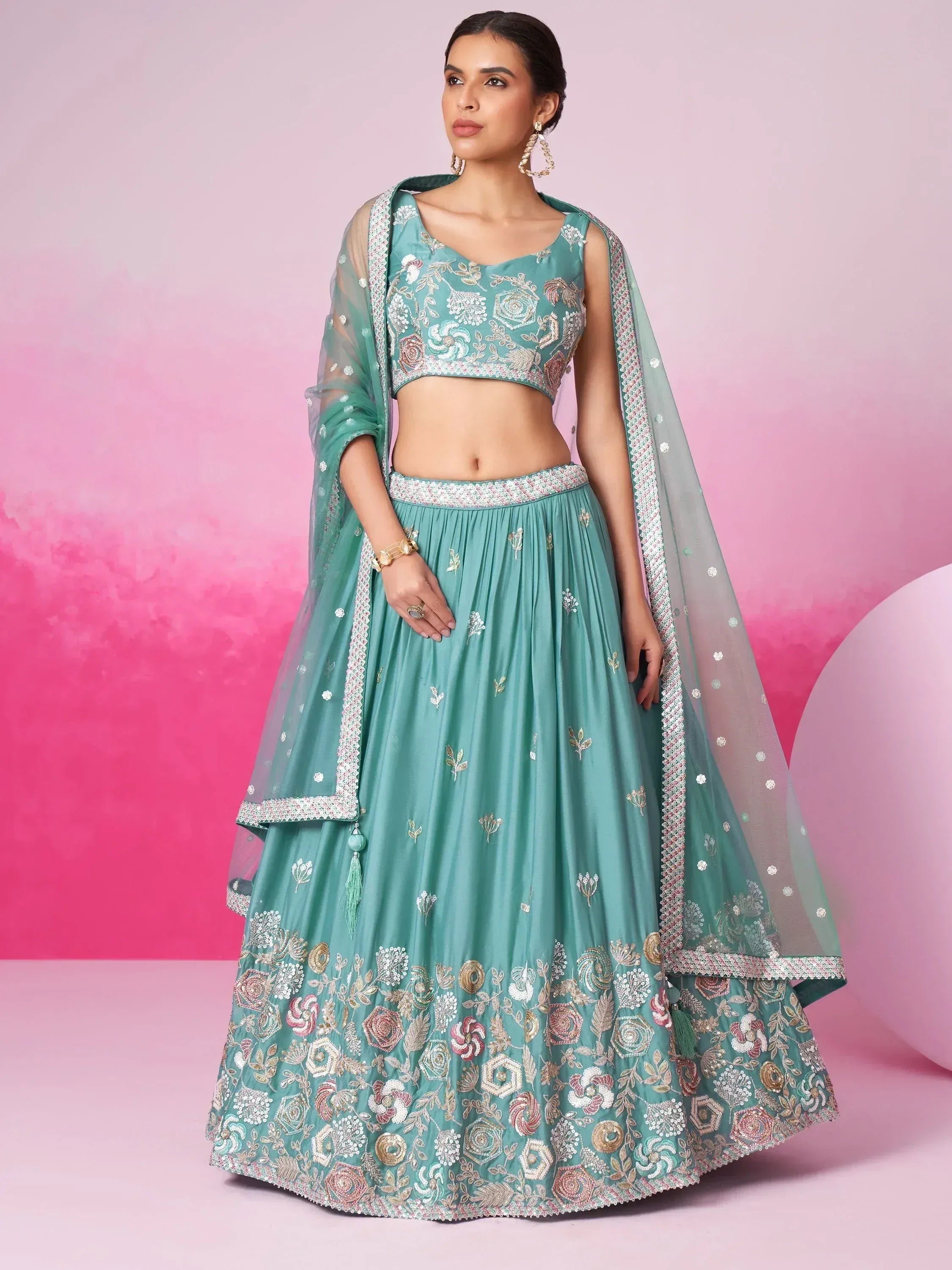 Teal embroidered lehenga choli with floral motifs and sheer dupatta, perfect for Indian ethnic occasions.