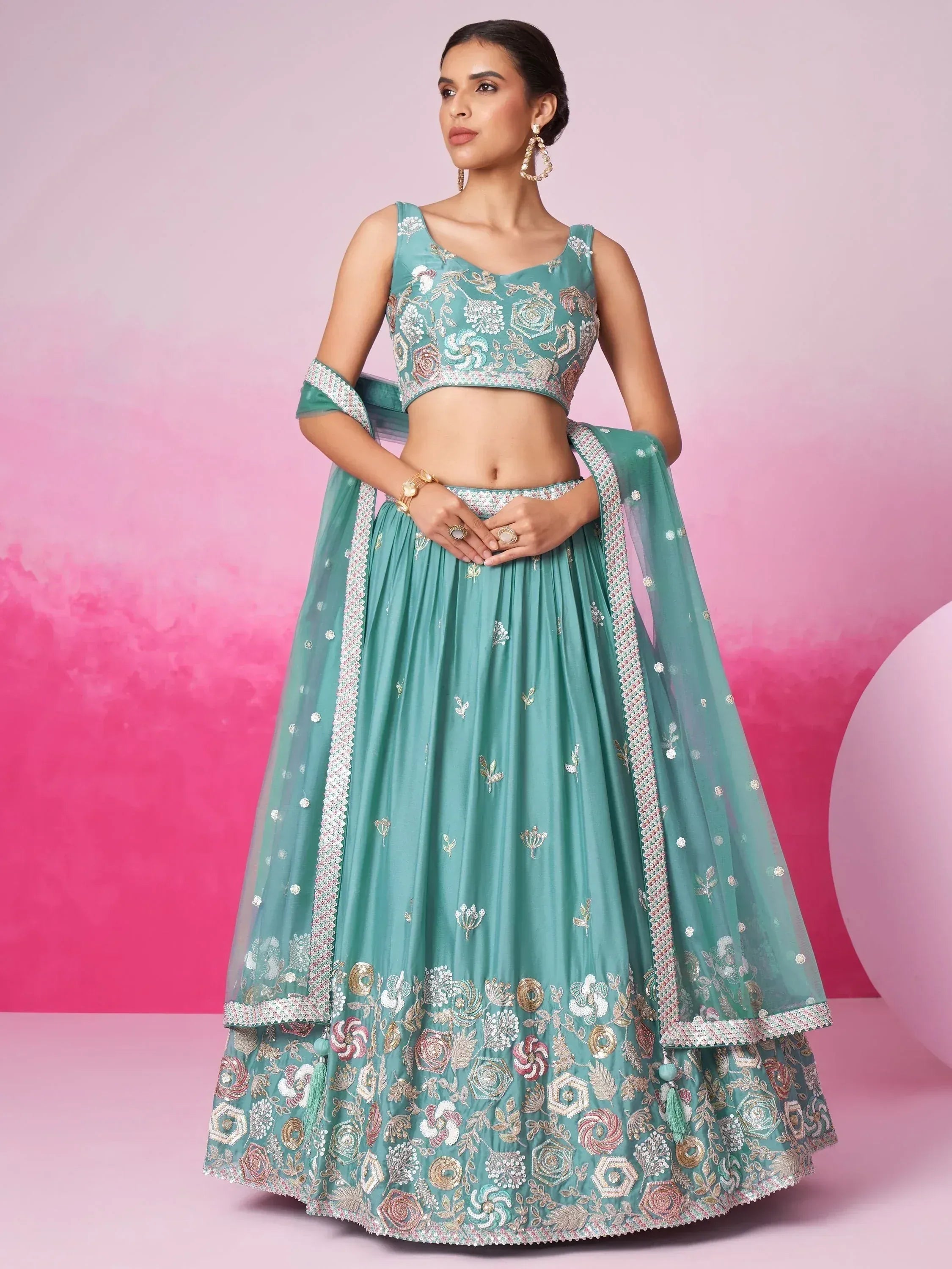 Teal embroidered lehenga choli with floral motifs, perfect for Indian weddings and festive occasions.