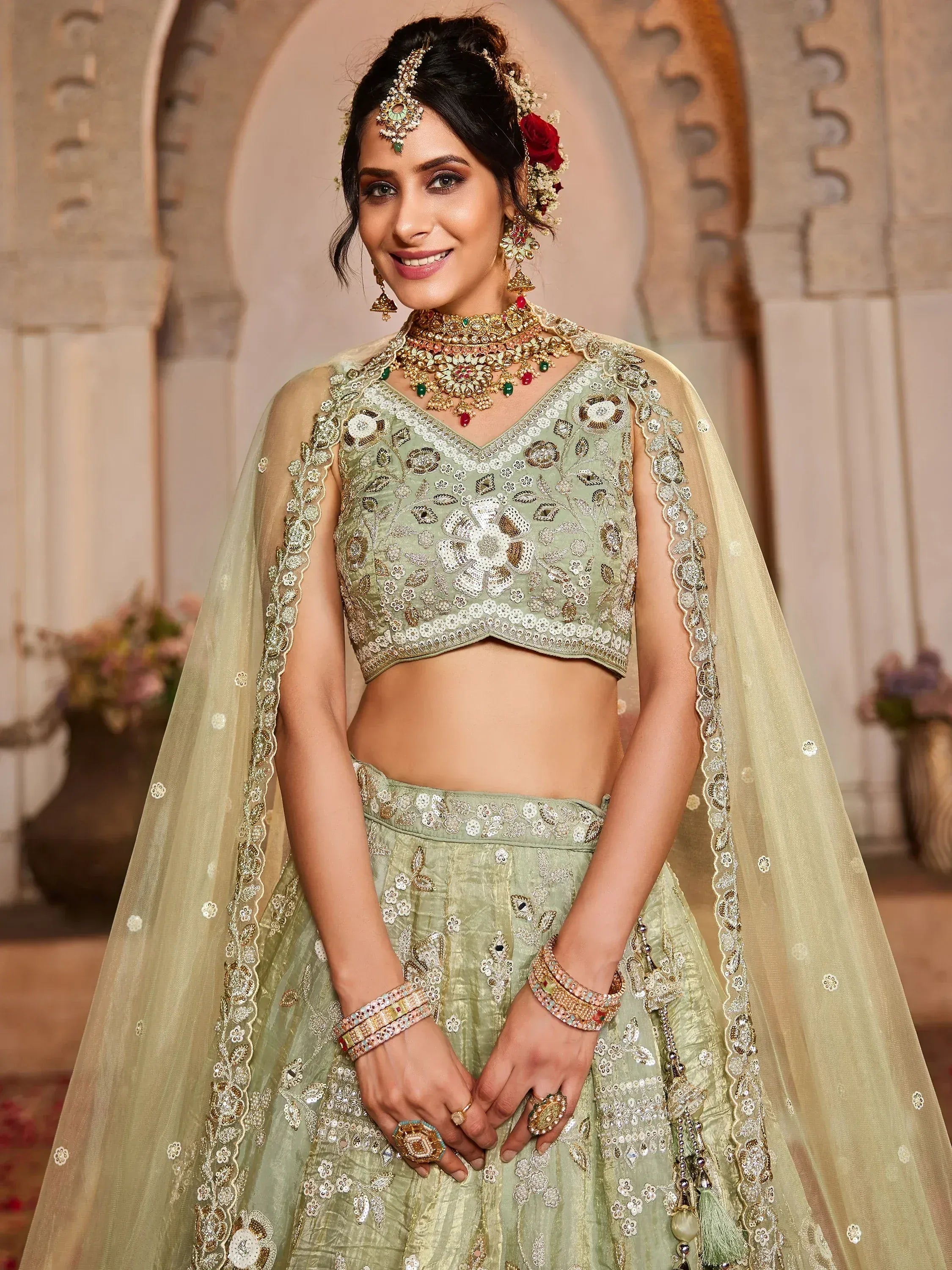 Elegant green embroidered lehenga choli with floral designs and matching dupatta, perfect for Indian weddings.