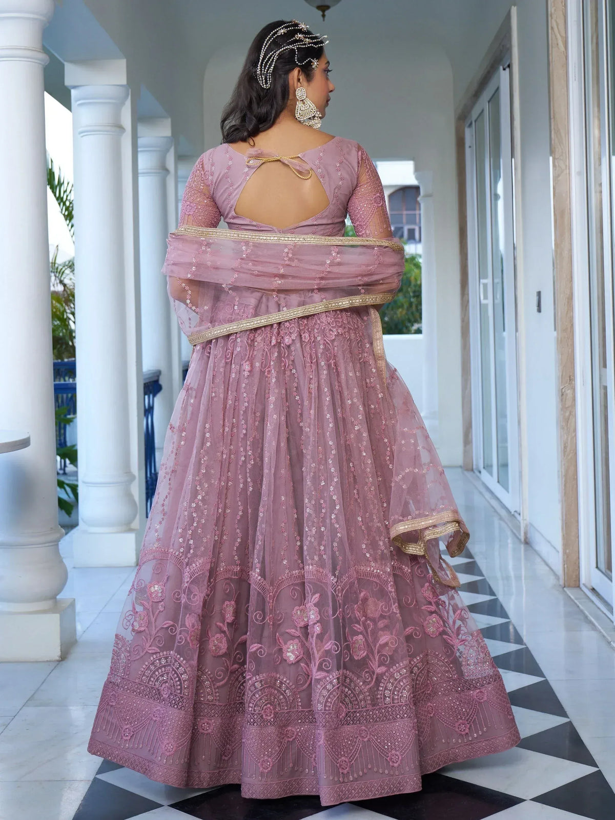 Pink embroidered lehenga choli with gold detailing, back view, perfect for Indian ethnic occasions.