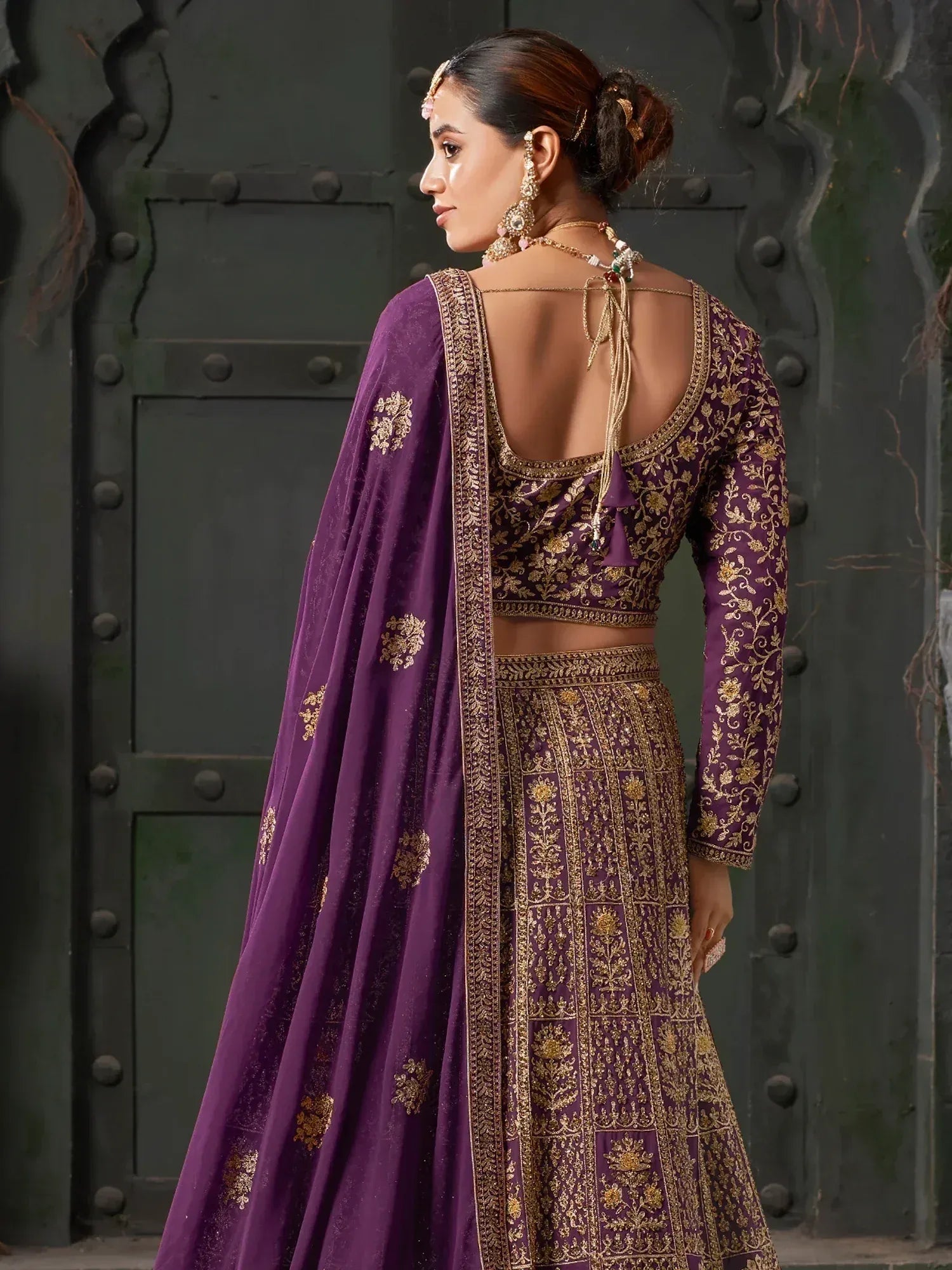 Purple embroidered lehenga choli with gold detailing, back view, ethnic Indian wear