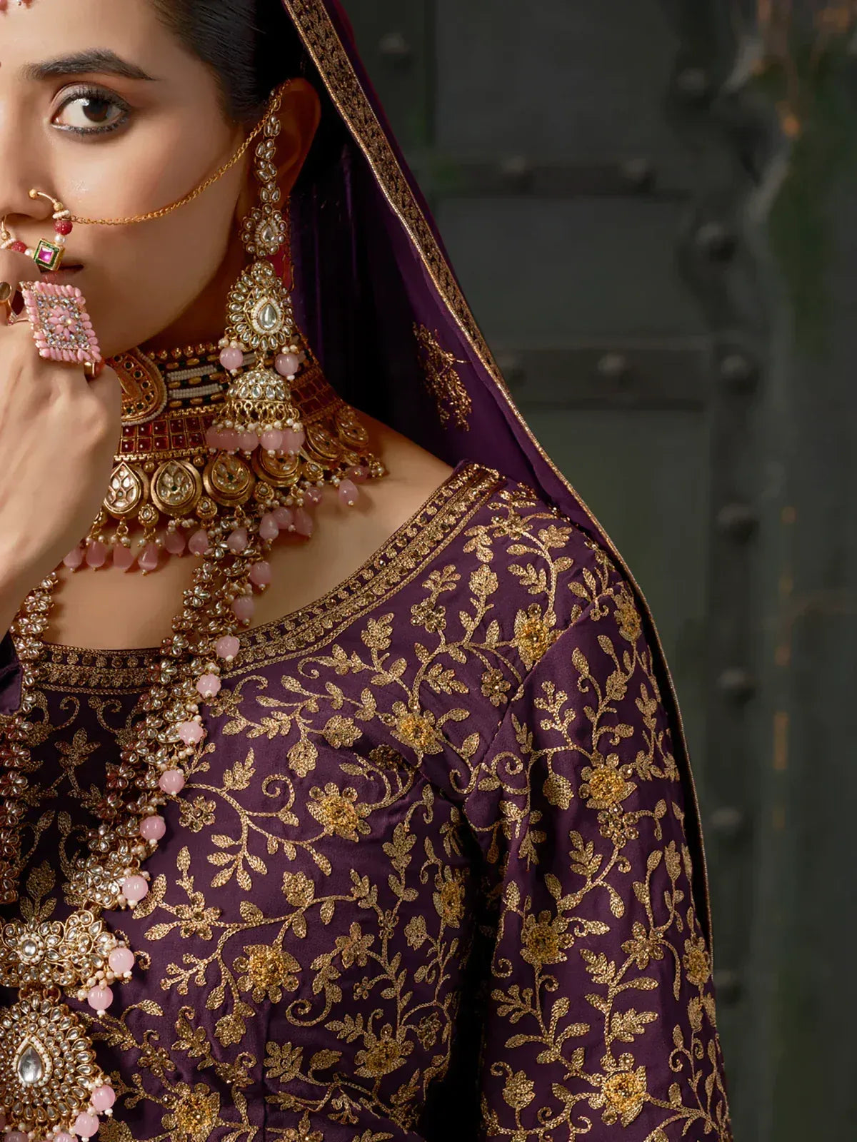 Purple ethnic wear with gold floral embroidery and traditional jewelry for Indian occasions