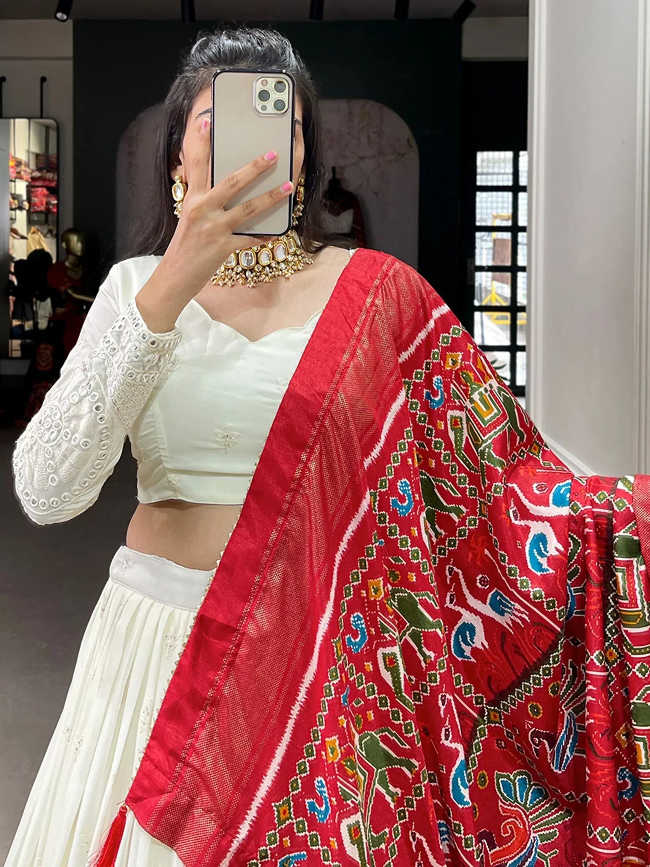 White embroidered lehenga choli with vibrant red printed dupatta, perfect for Indian ethnic wear occasions.