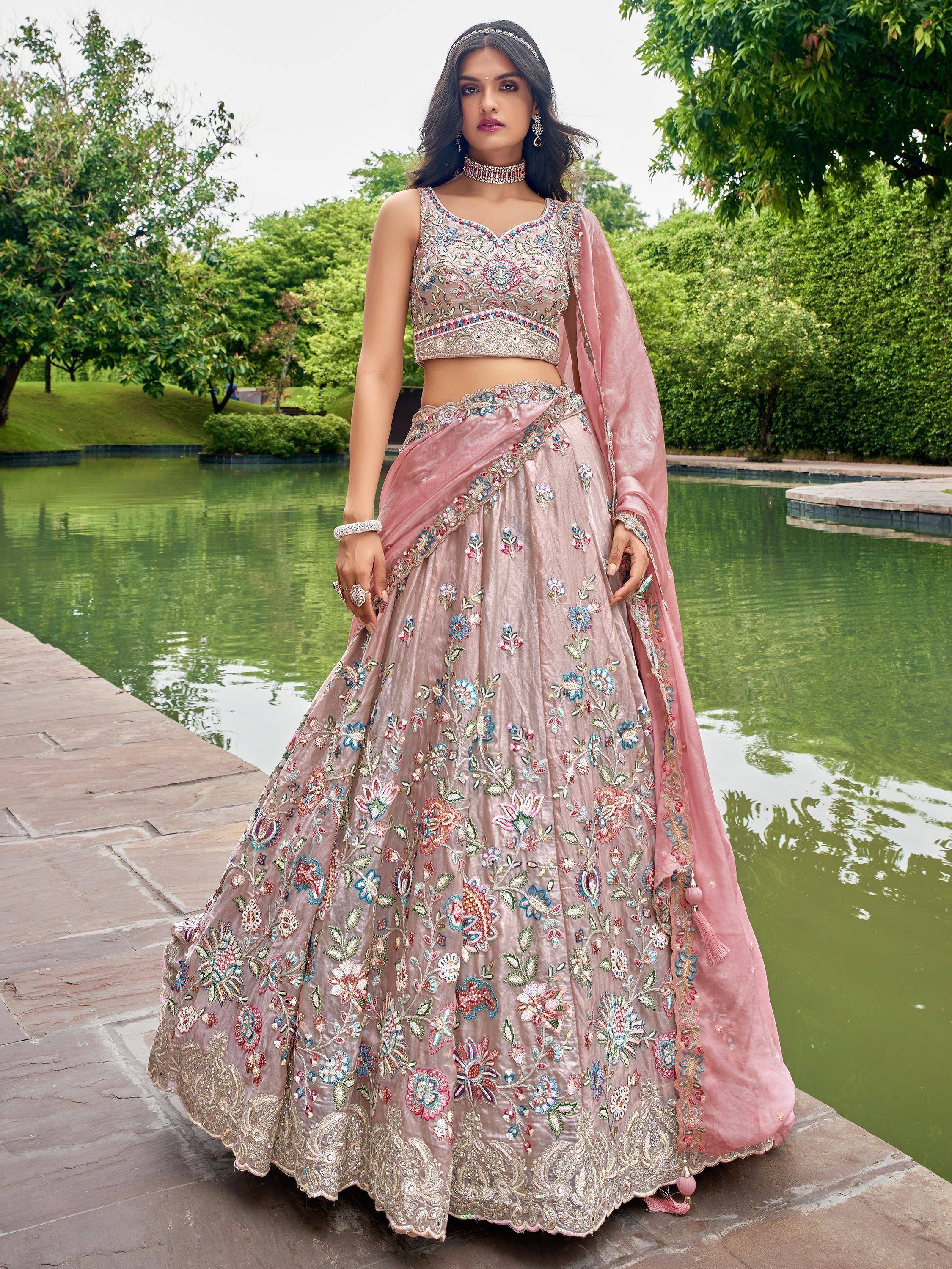 Pink embroidered lehenga choli with floral motifs, perfect for Indian weddings and festive occasions.