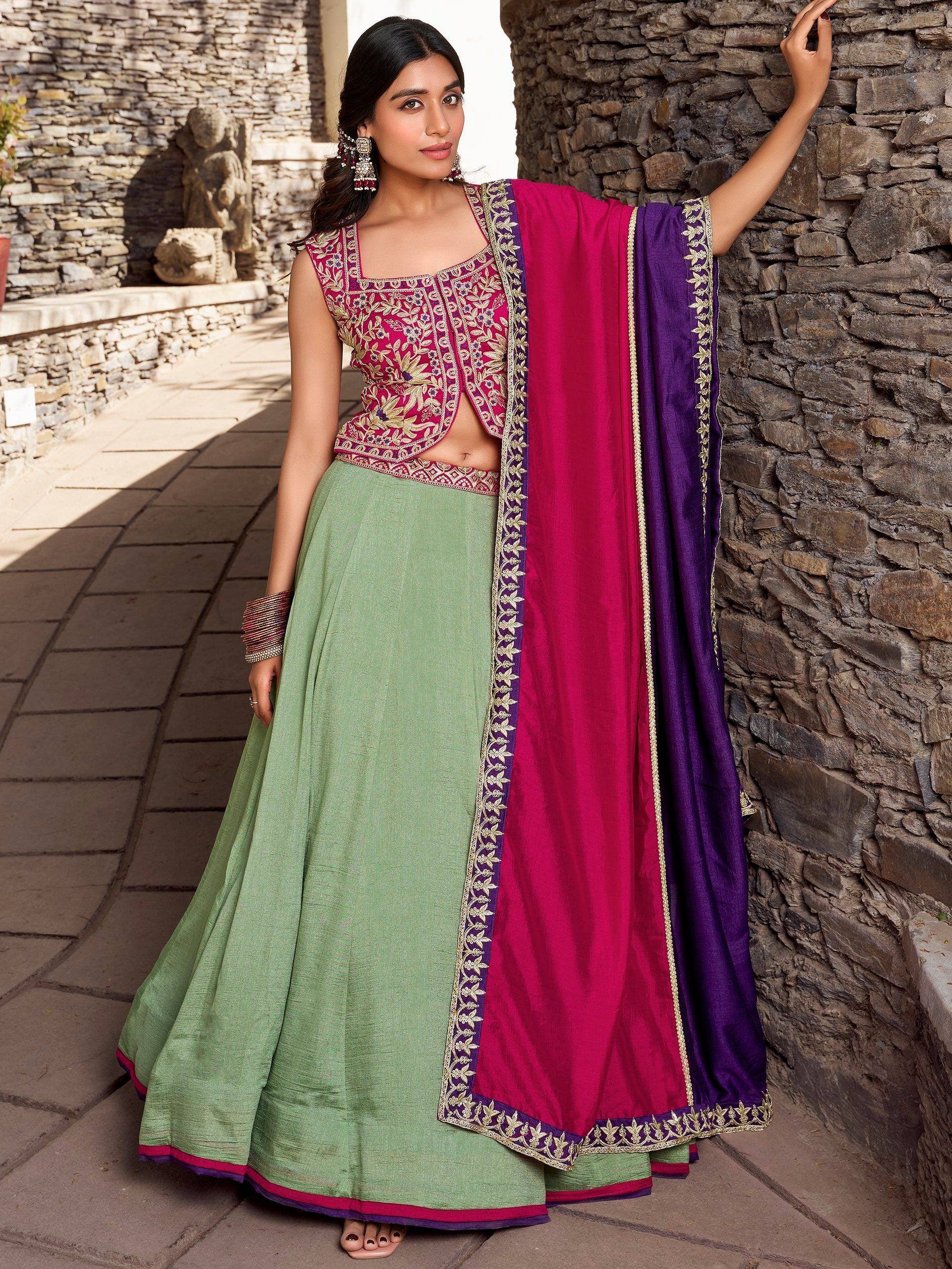 Woman in green lehenga with pink and purple embroidered dupatta, Indian ethnic wear