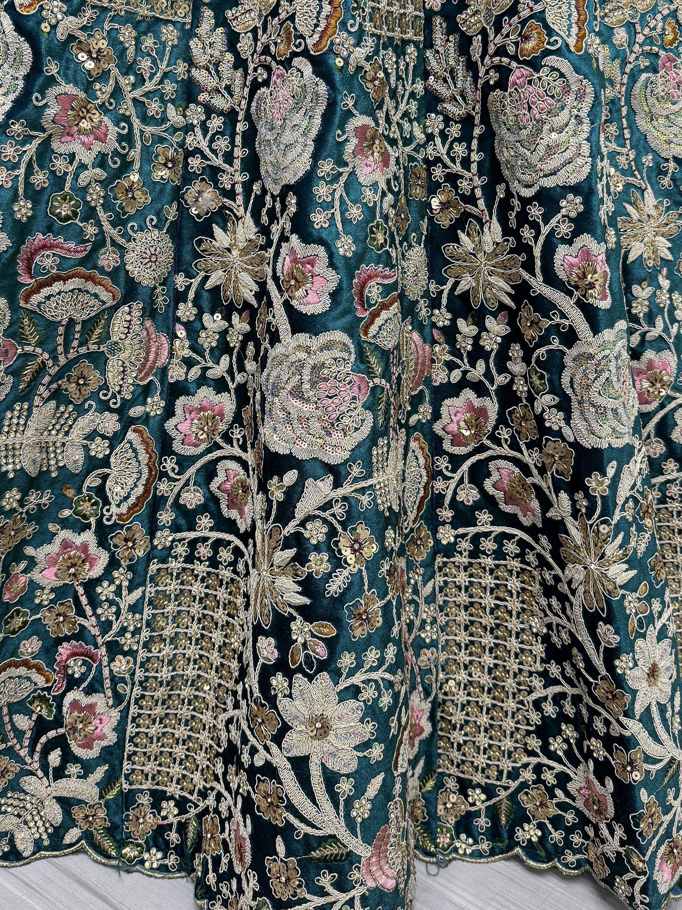 Teal velvet lehenga with intricate floral embroidery and sequin work, perfect for Indian ethnic wear.