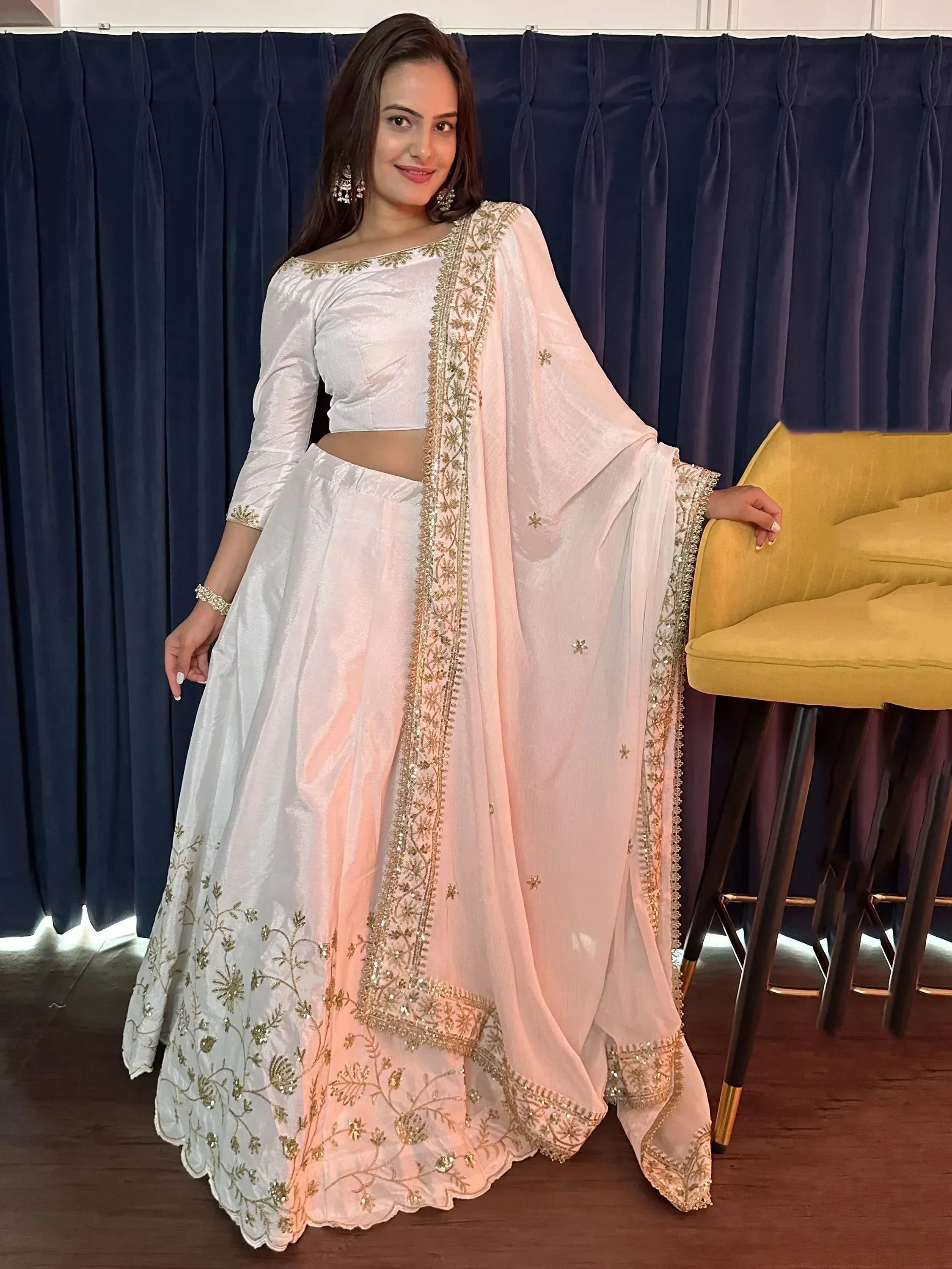 White and gold embroidered lehenga choli with floral detailing, perfect for Indian ethnic wear occasions.