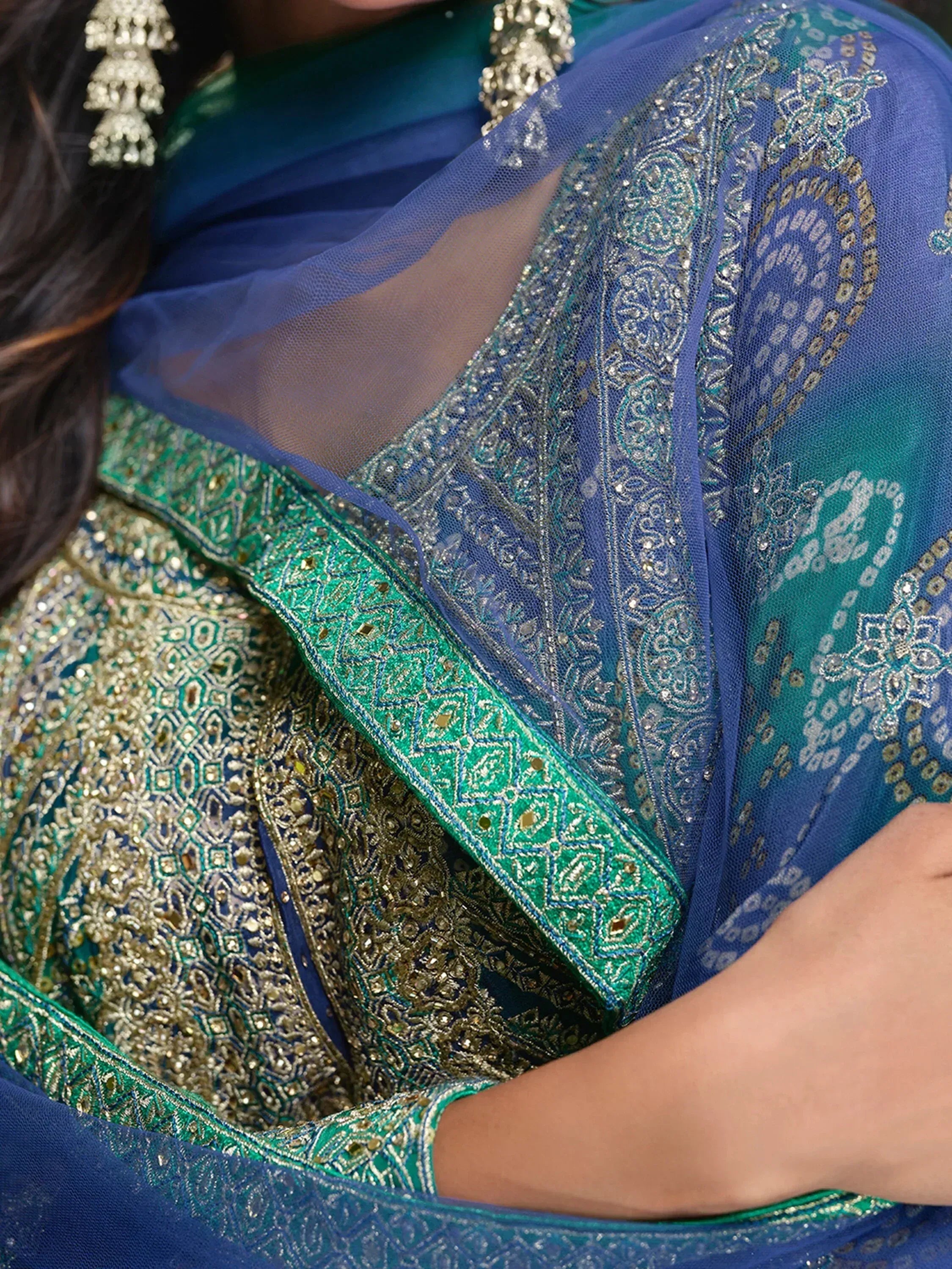 Blue and green embroidered lehenga choli with detailed zari work and sheer dupatta