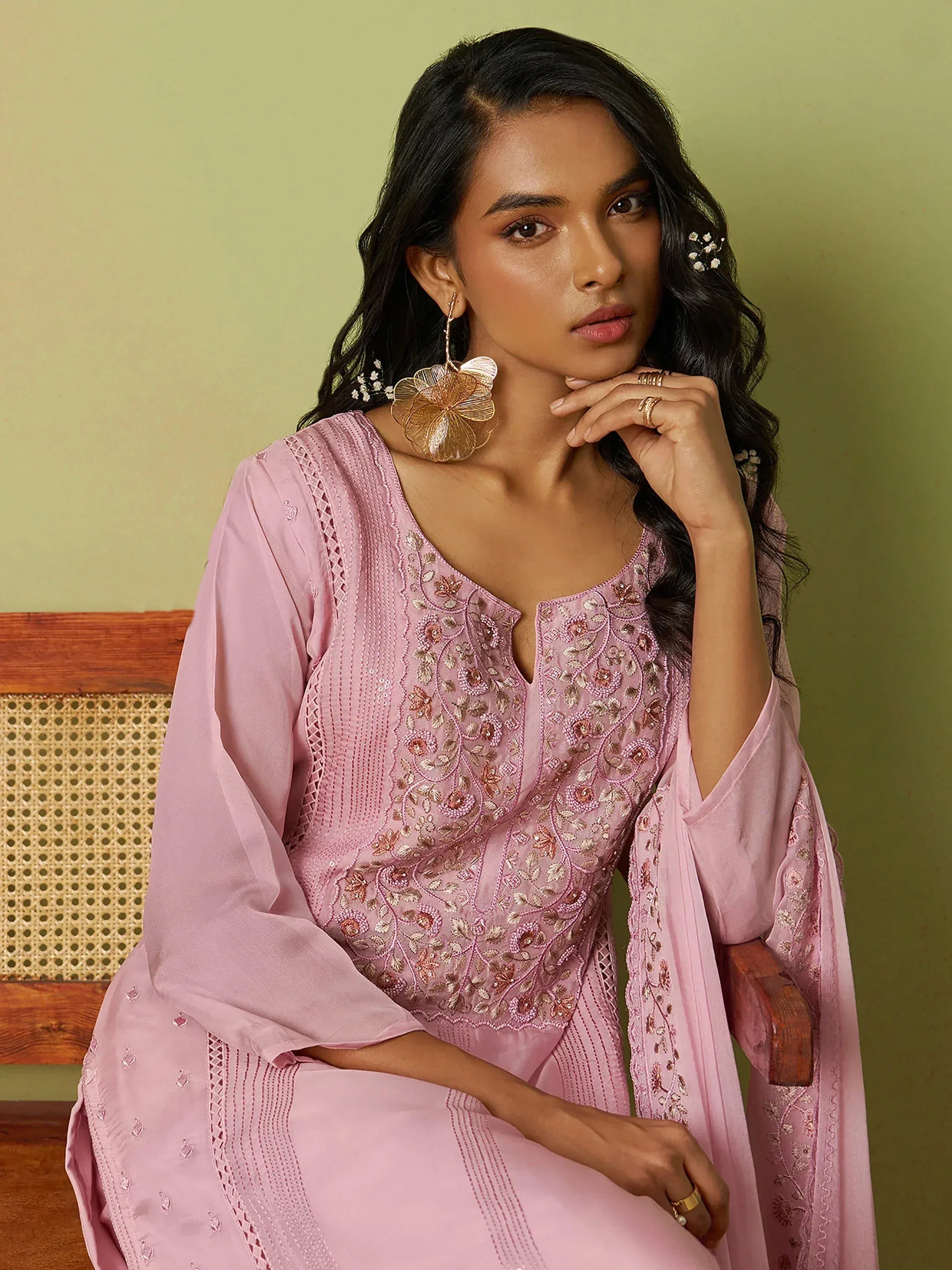 Pink embroidered salwar kameez with floral detailing, perfect for ethnic wear occasions.