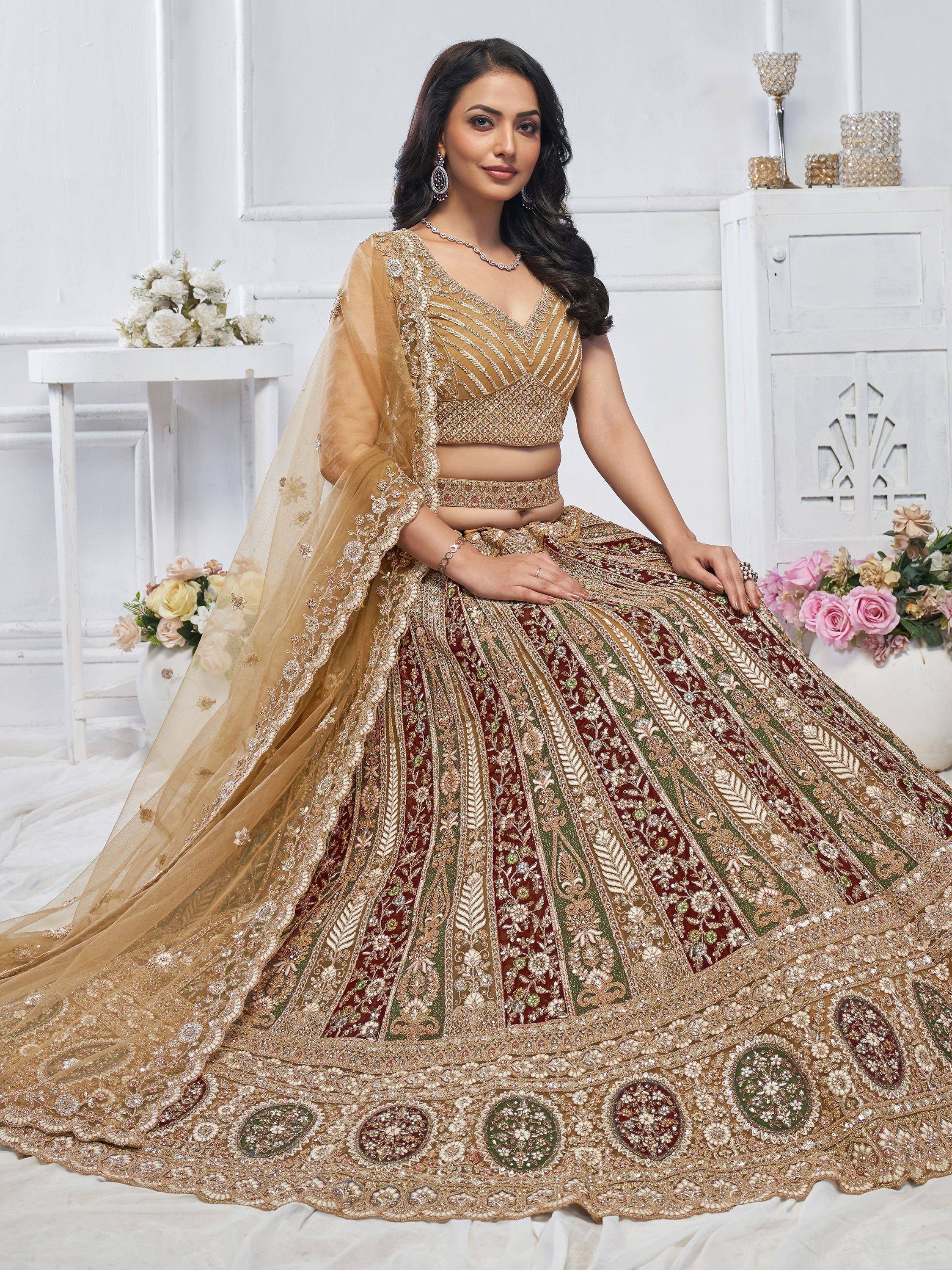 Elegant Indian bridal lehenga choli with intricate gold embroidery, maroon and green panels, and sheer dupatta for wedding wear