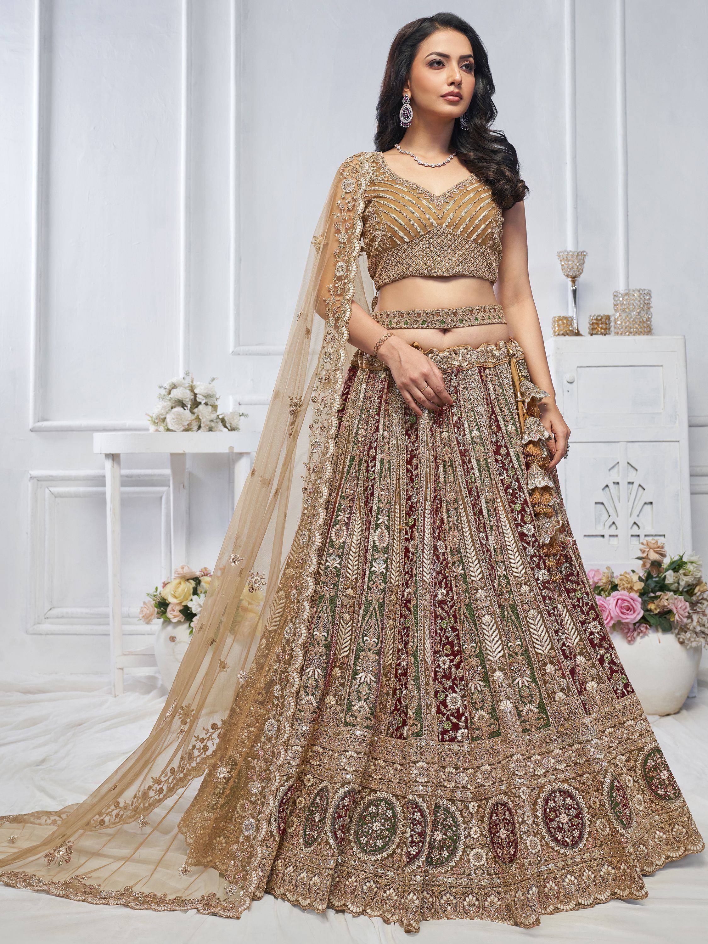 Elegant maroon and gold embroidered lehenga choli with sheer dupatta, perfect for Indian weddings and festive occasions.