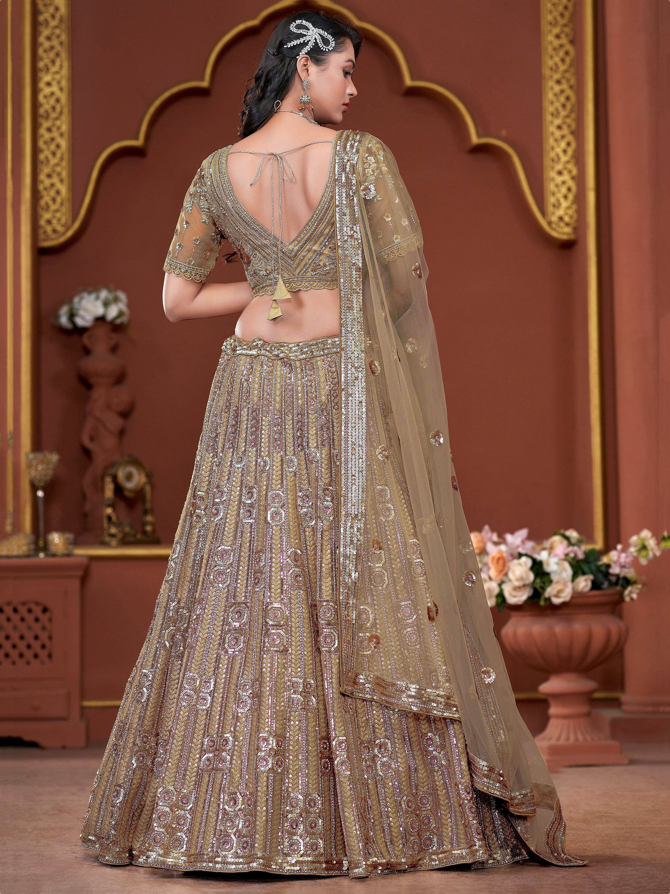 Gold embroidered lehenga choli with backless blouse and sheer dupatta, perfect for Indian weddings and festivals.
