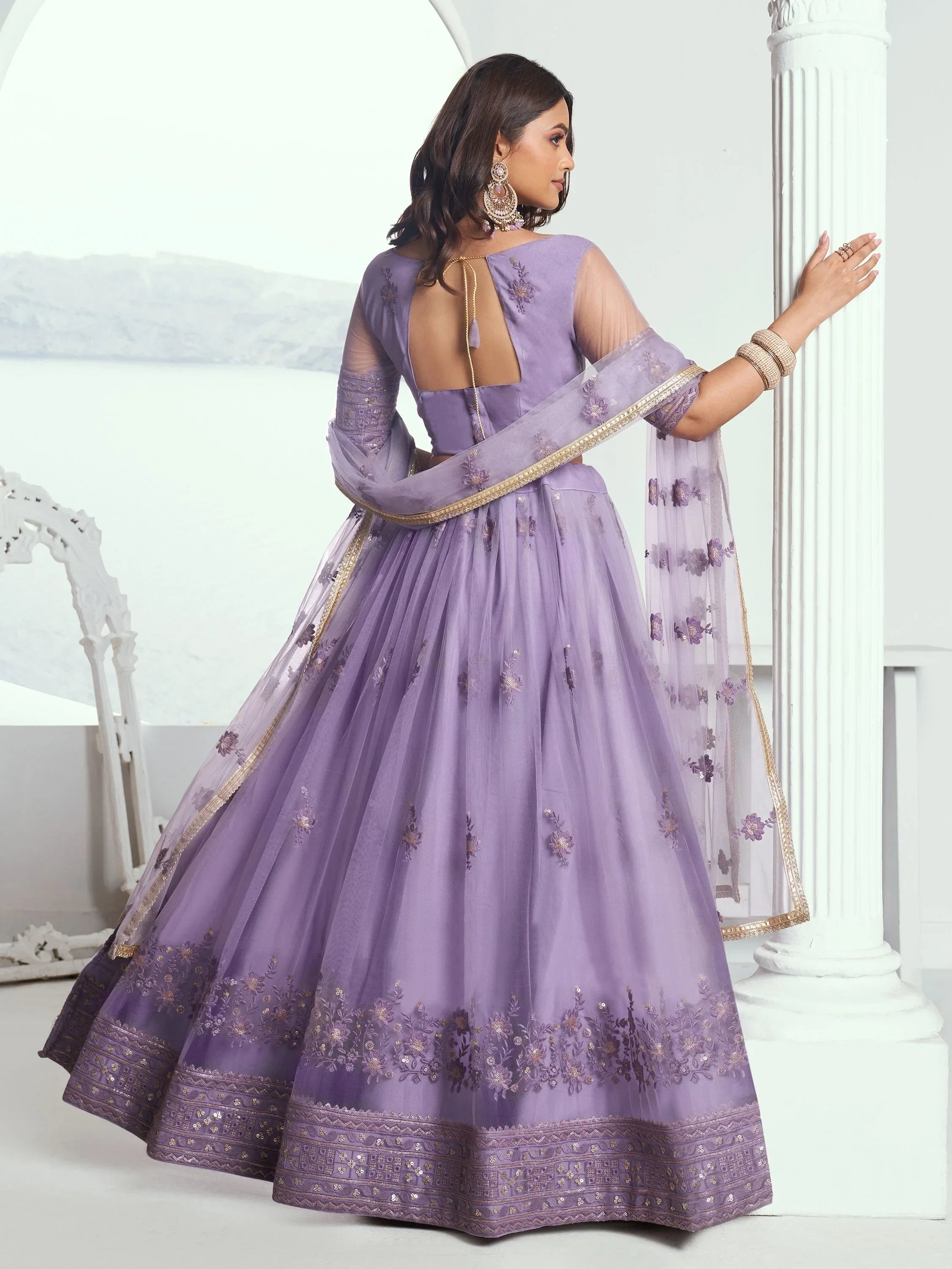 Lavender designer lehenga choli with floral embroidery and sheer dupatta, perfect for Indian ethnic occasions.