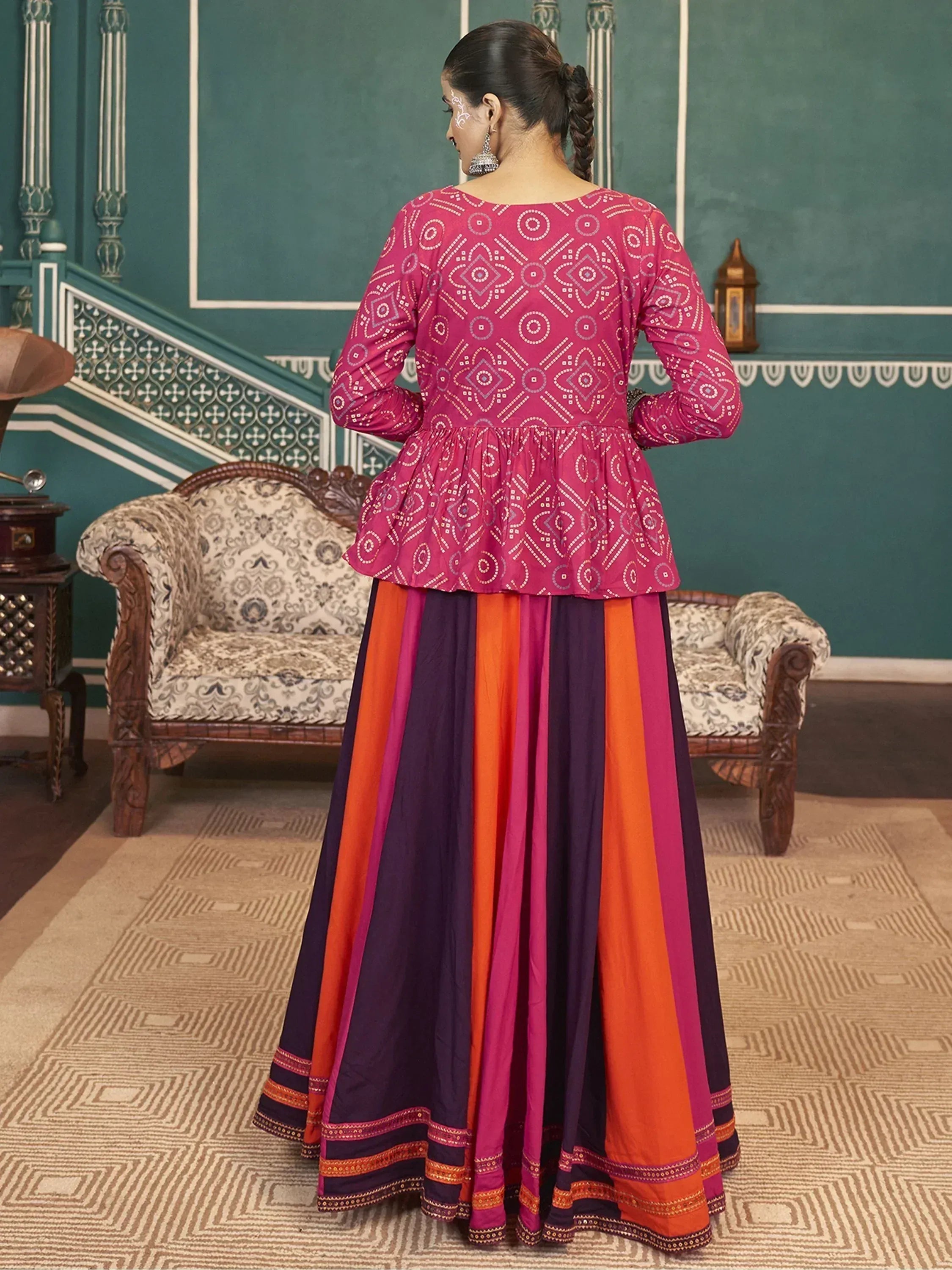 Woman in pink printed peplum top with colorful striped skirt, Indian ethnic wear