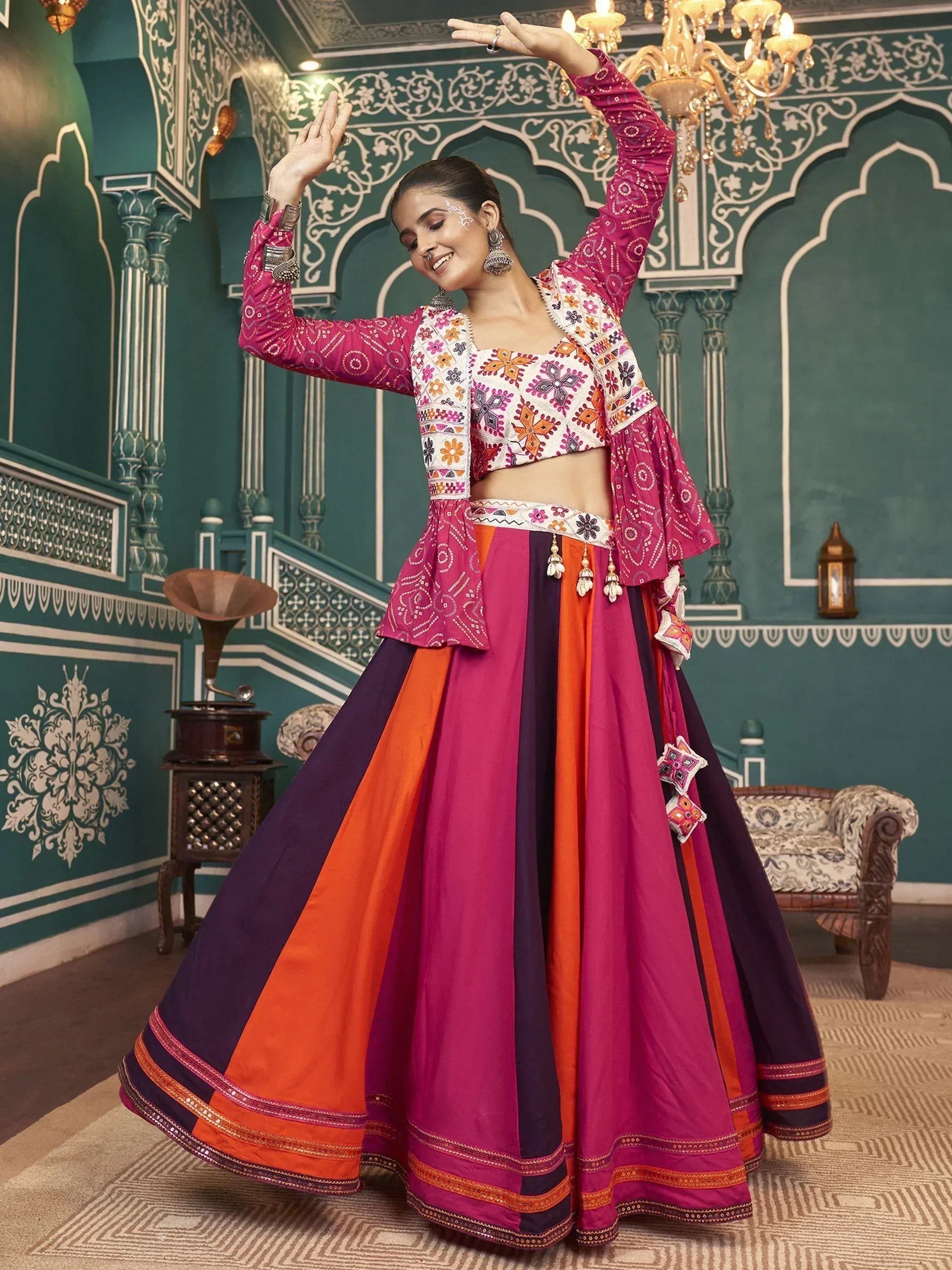 Woman in vibrant Indian lehenga choli with floral embroidery, dancing in ornate palace setting