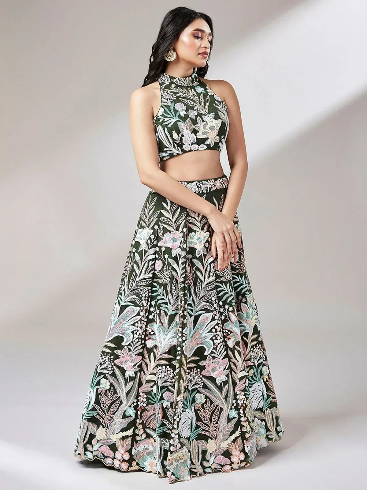 Green floral embroidered lehenga choli with halter neck crop top, perfect for Indian ethnic occasions