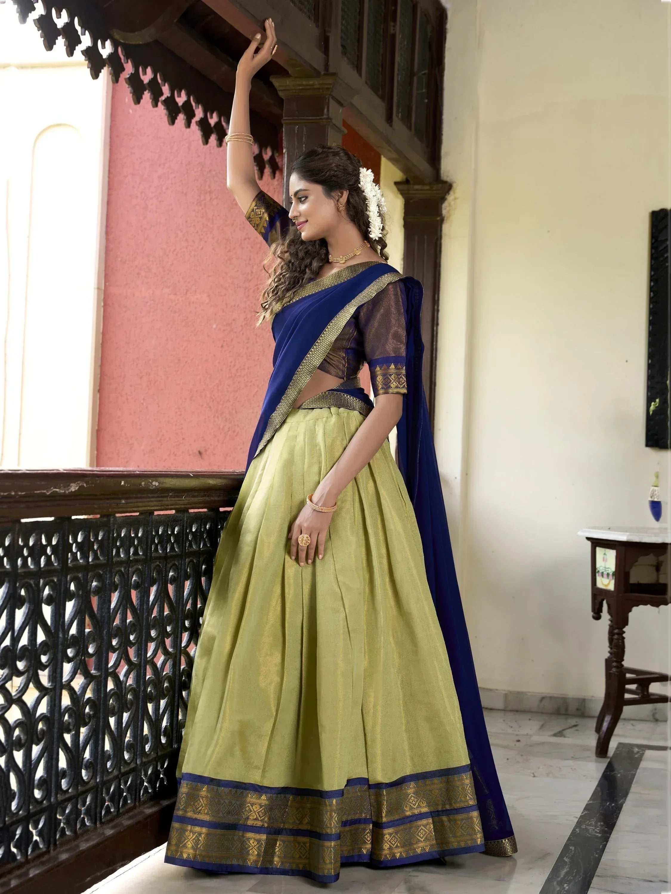 Woman in elegant blue and olive green lehenga choli with gold border, traditional Indian ethnic wear