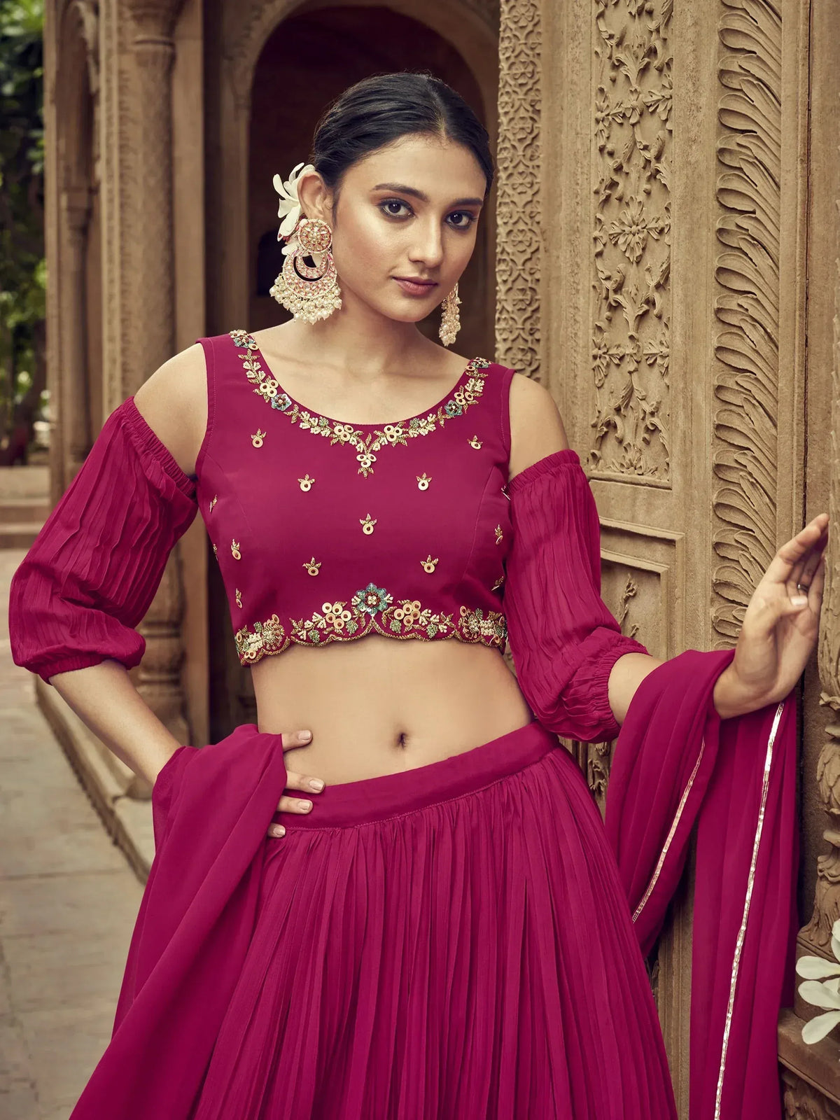 Magenta designer lehenga choli with floral embroidery, cold shoulder top, and pleated skirt for Indian ethnic wear