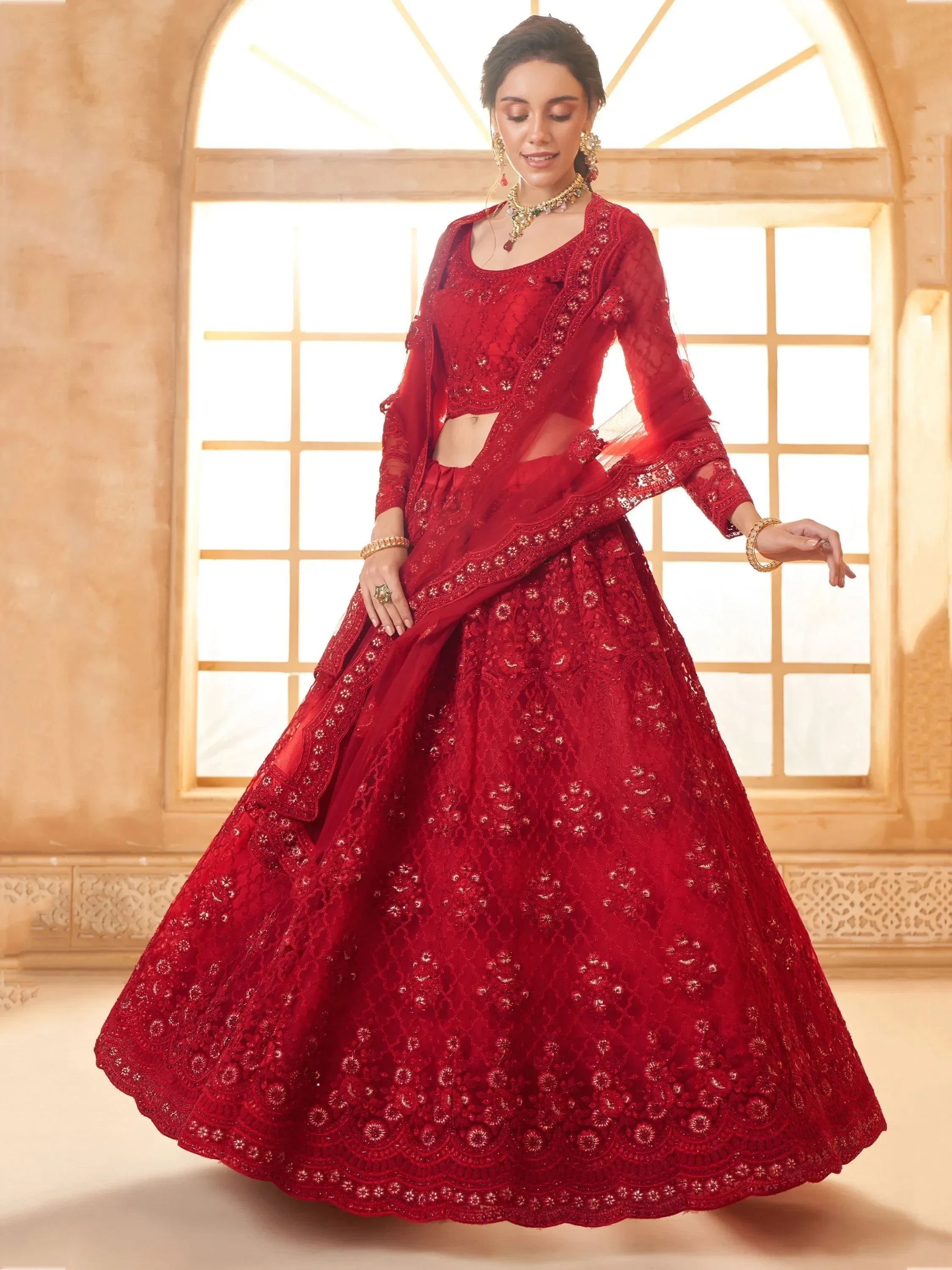 Red embroidered lehenga choli with sheer dupatta, perfect for Indian weddings and festive occasions