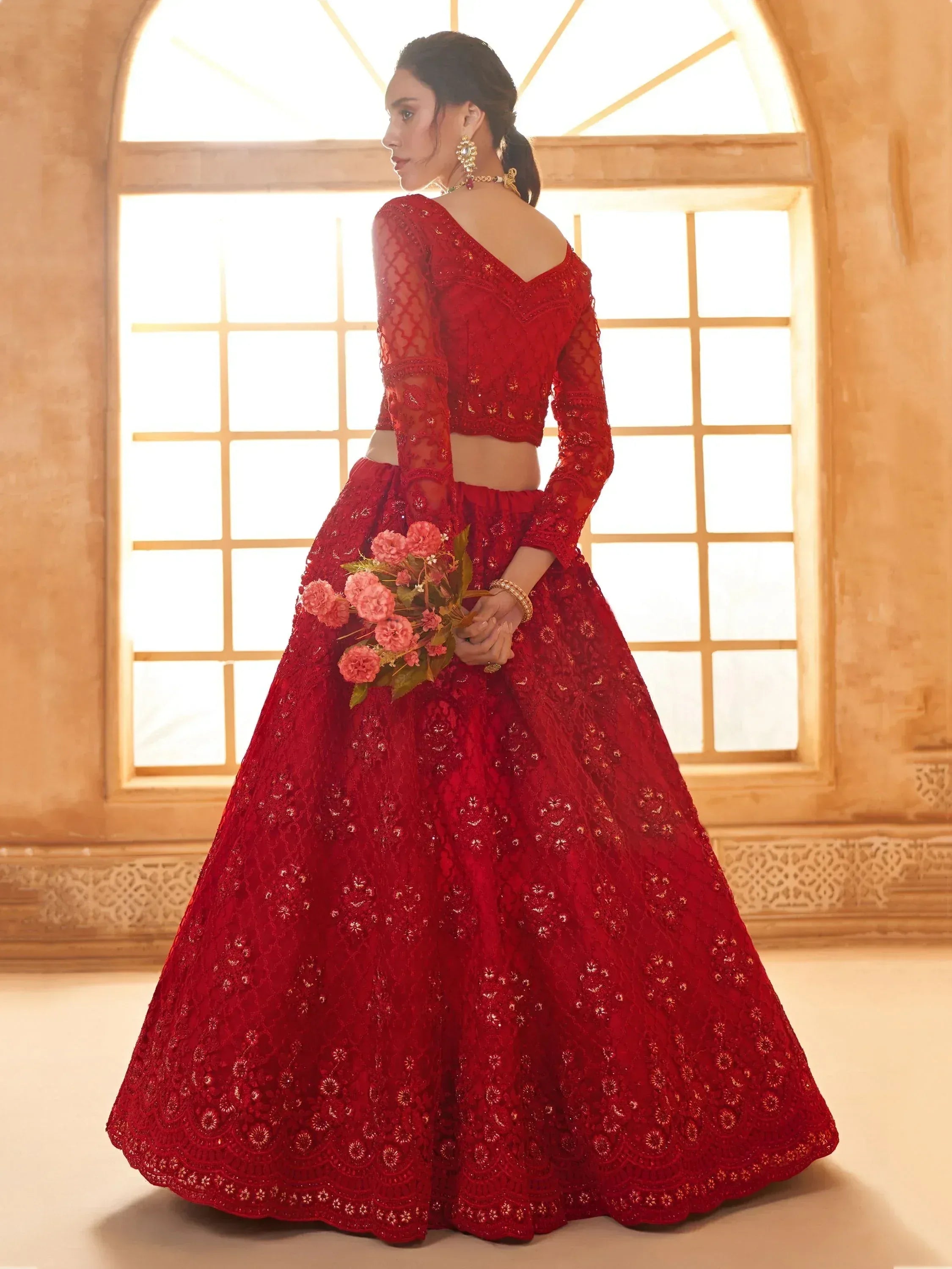 Red embroidered lehenga choli with lace detailing, perfect for Indian weddings and festive occasions