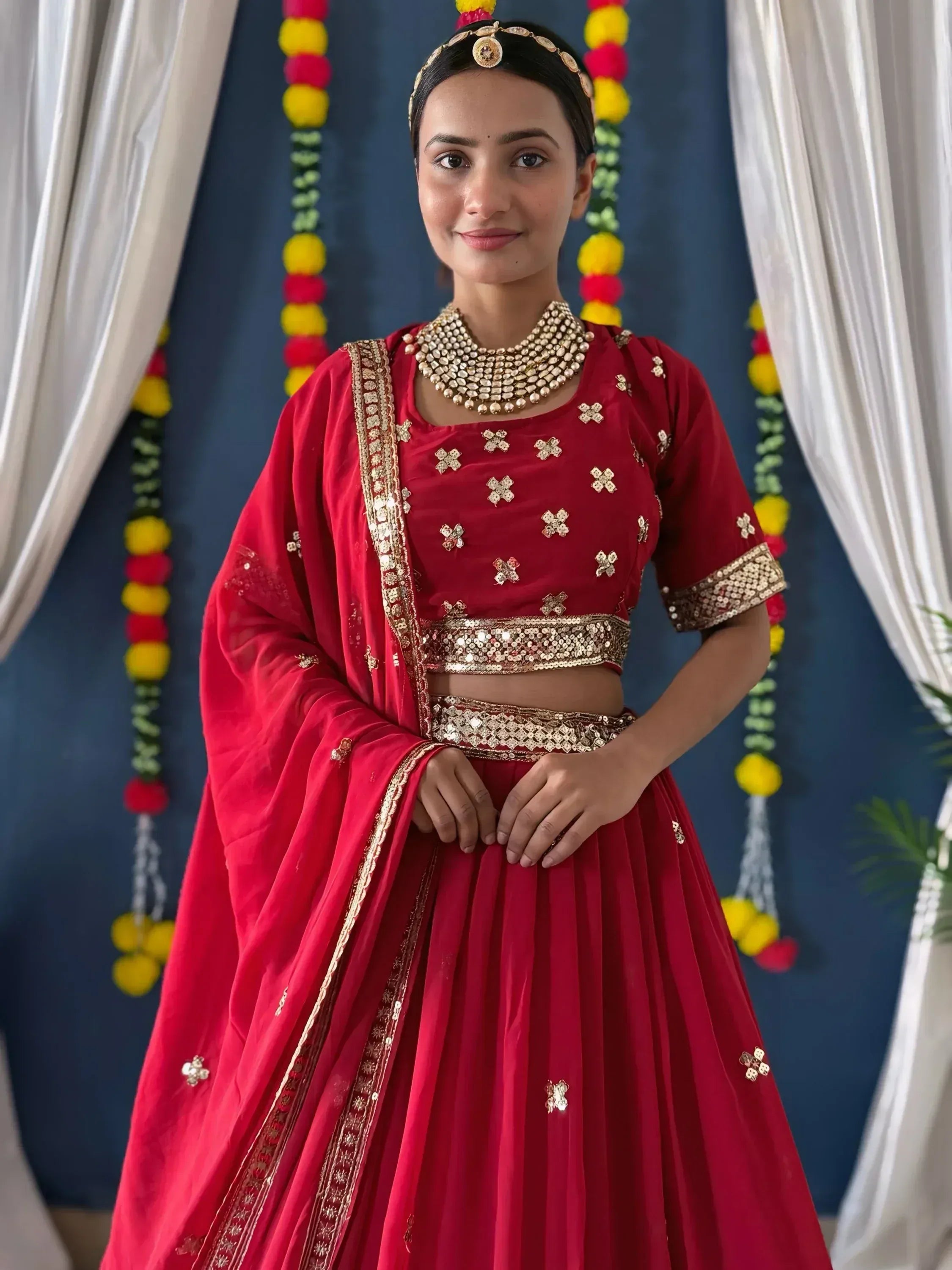 Red designer lehenga choli with gold embroidery, perfect for Indian weddings and festive occasions