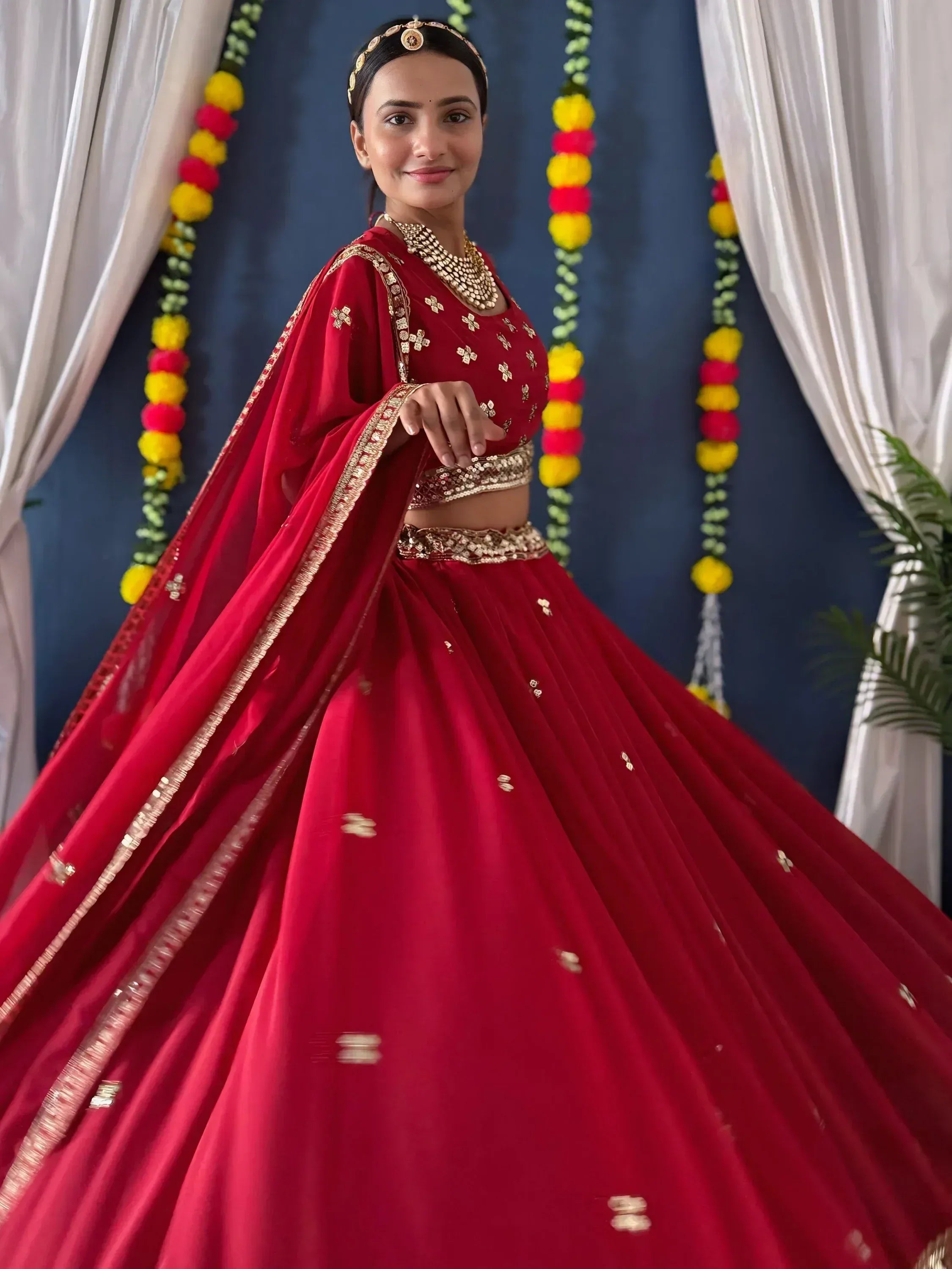 Red designer lehenga choli with gold embroidery, perfect for Indian weddings and festive occasions